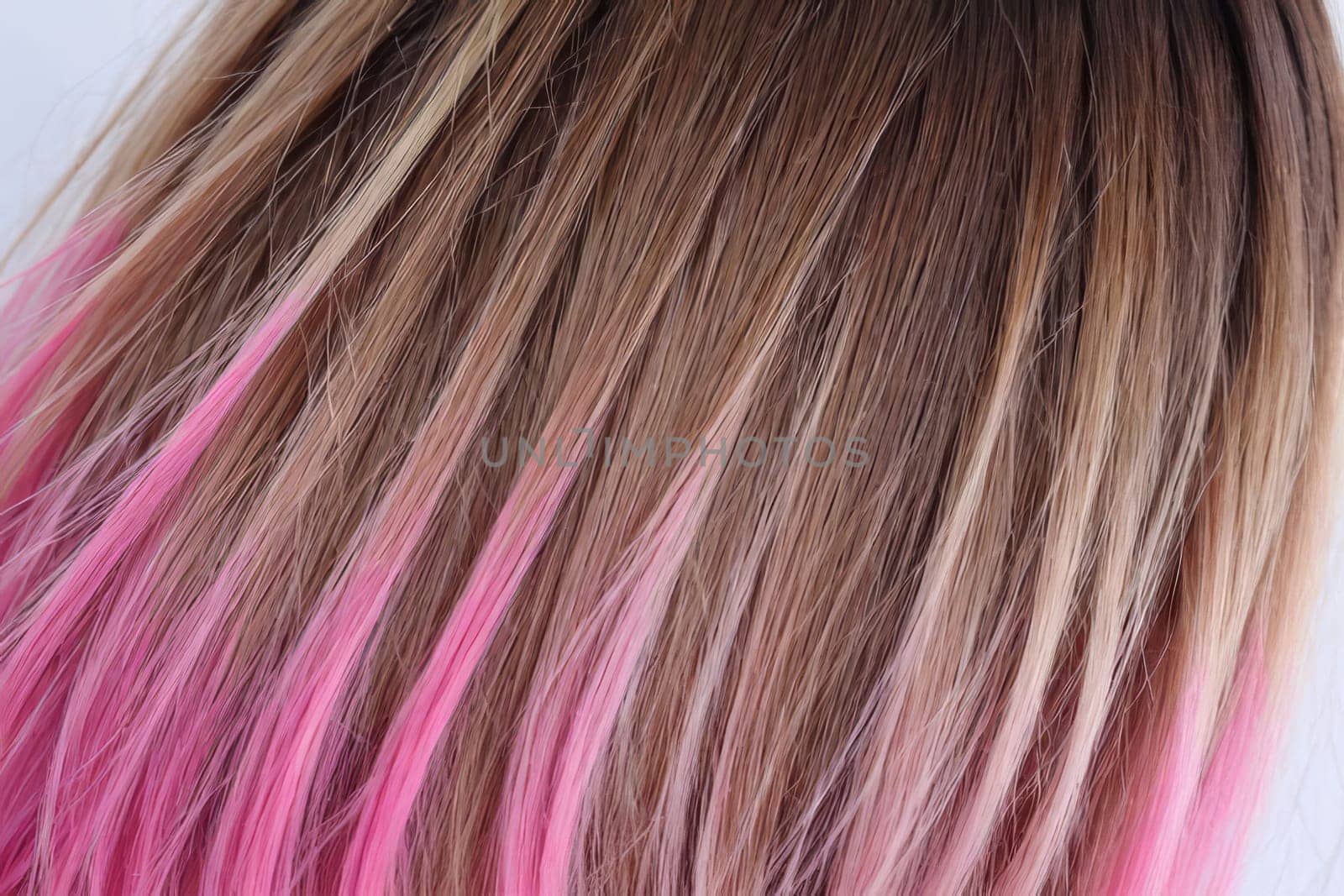 A mesmerizing close-up photo capturing the ombre elegance of beautiful pink hair, showcasing a seamless blend of delicate hues and tones