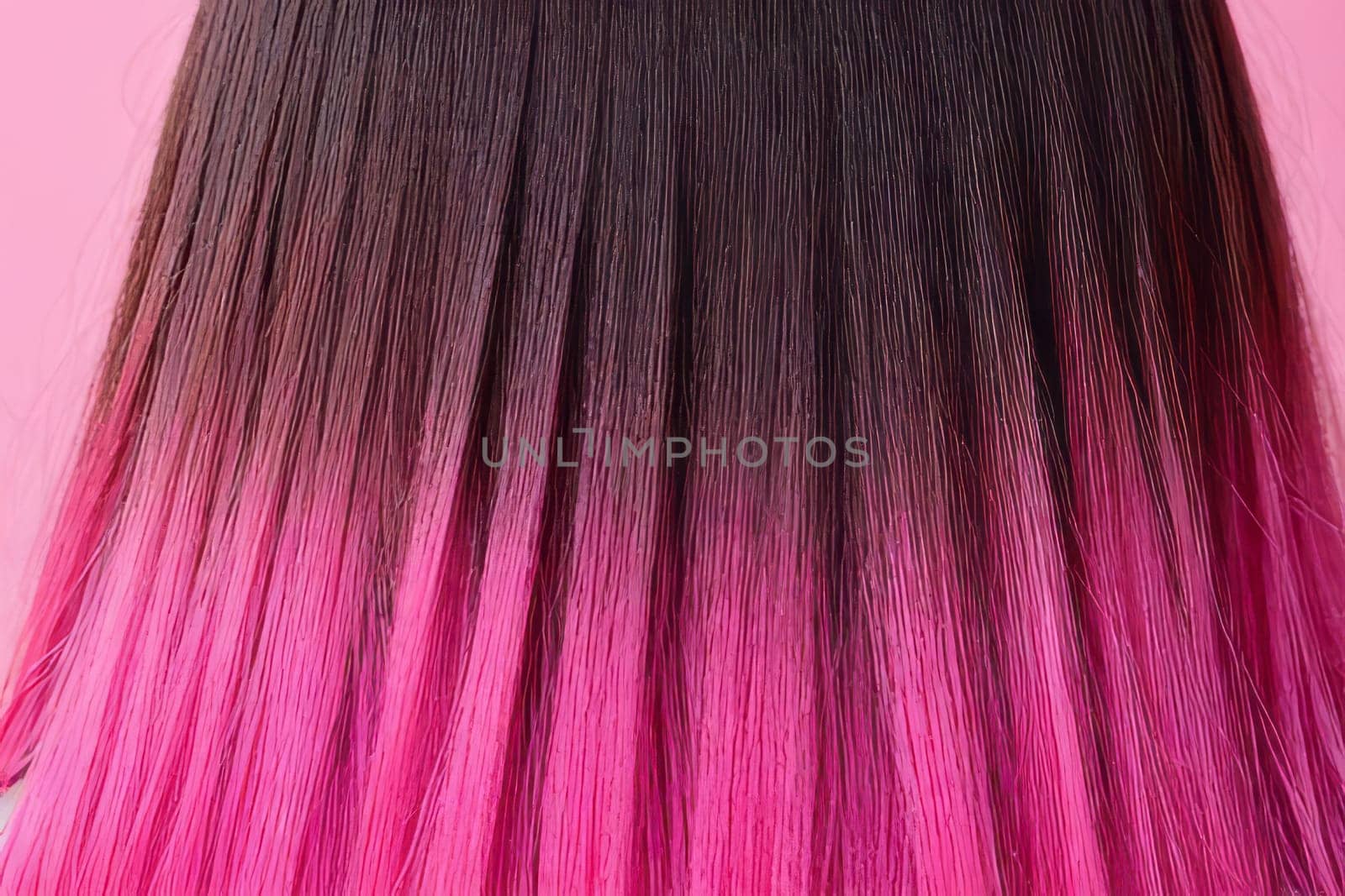 A captivating close-up view of the beautiful pink hair displays the artistic ombre technique, exuding a sense of glamour and refinement