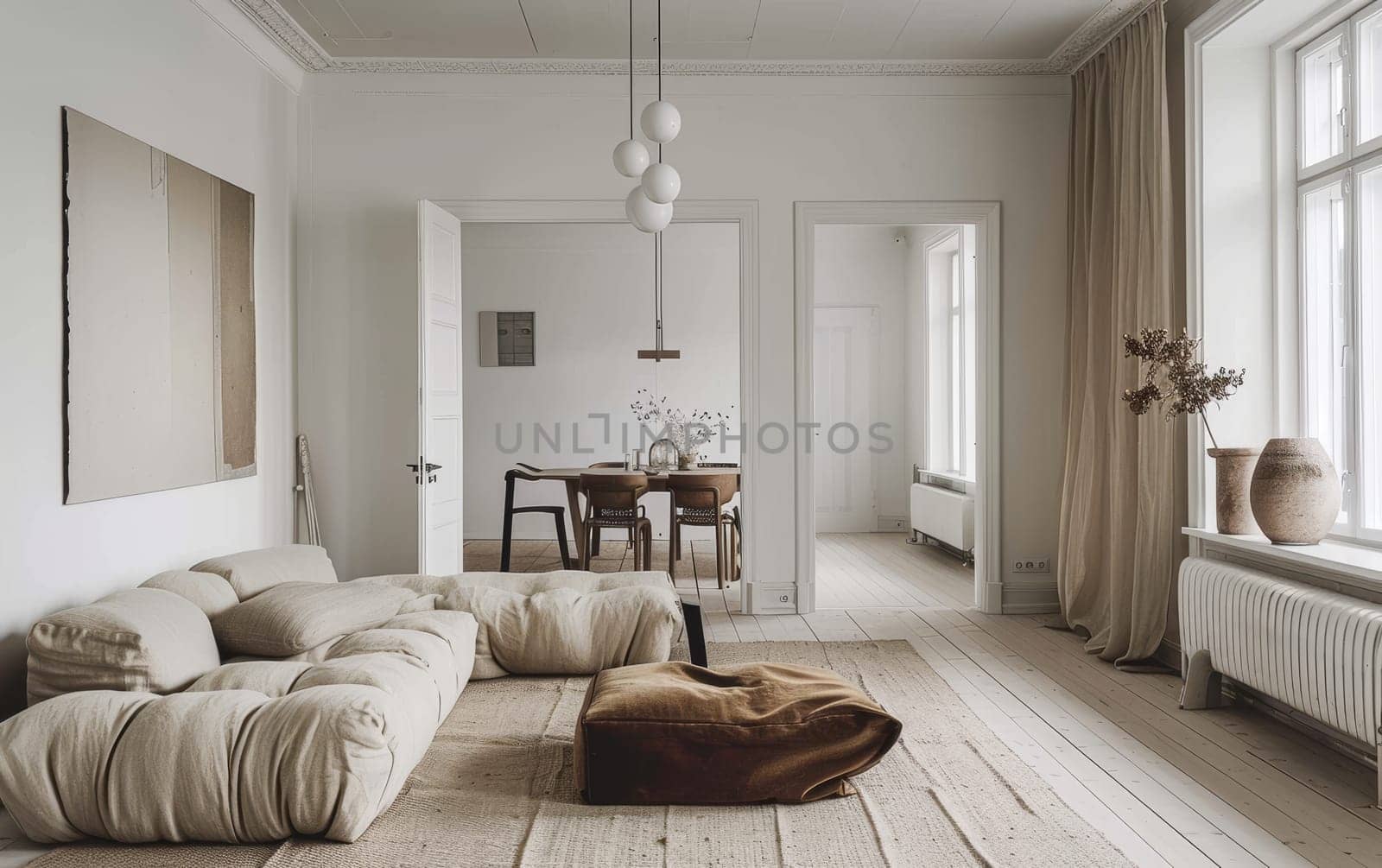 Scandinavian living room with a spacious and airy feel. Neutral decor and ample light highlight elegant simplicity