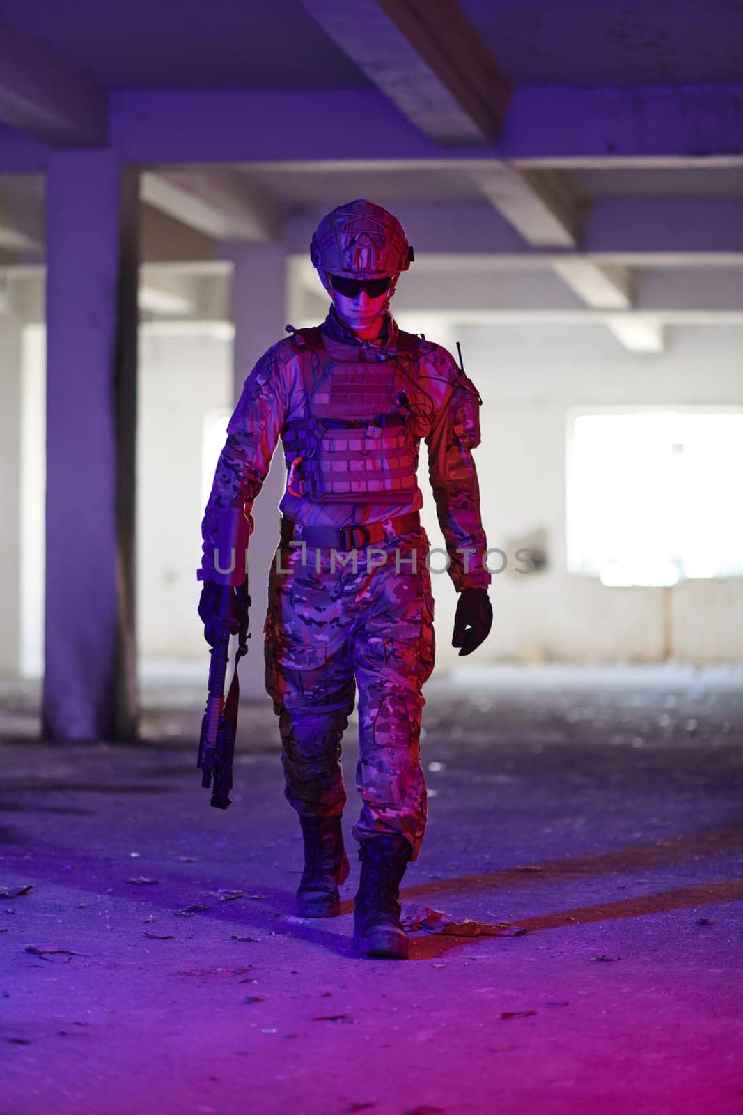 A professional soldier undertakes a perilous mission in an abandoned building illuminated by neon blue and purple lights.