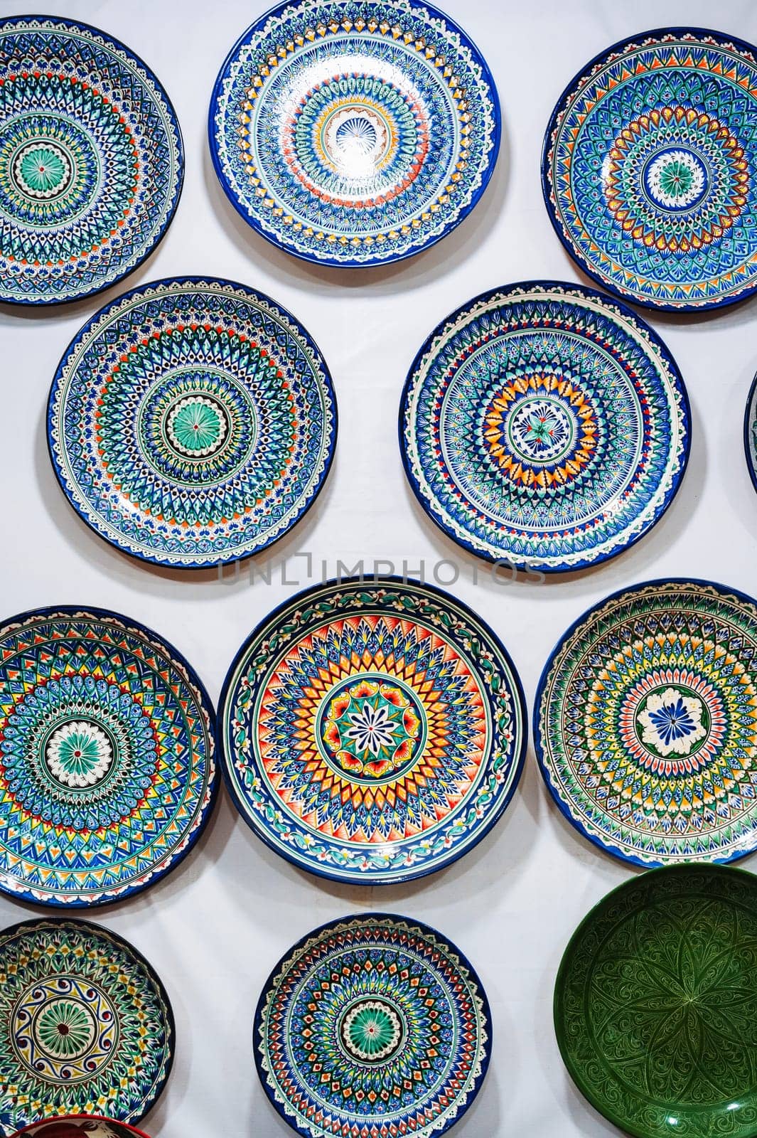 Uzbek handmade ceramic plates with hand-painted traditional ethnic Oriental Asian patterns in tableware store