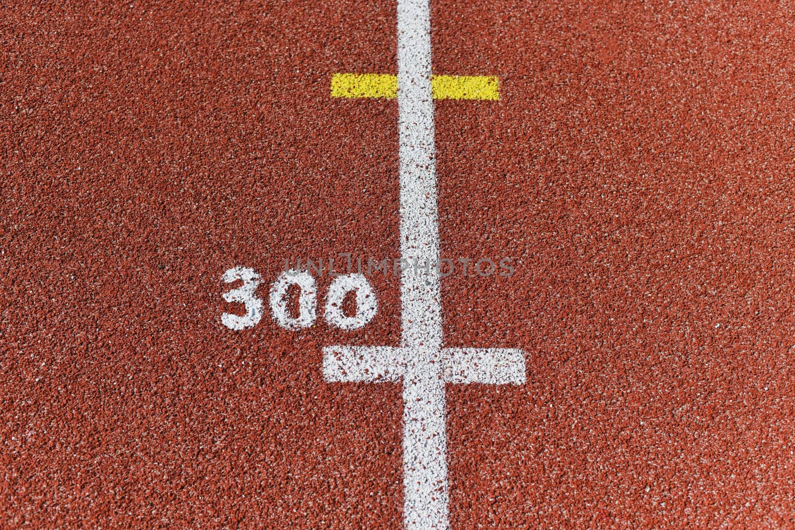 Three hundred meter mark on a running track at a stadium