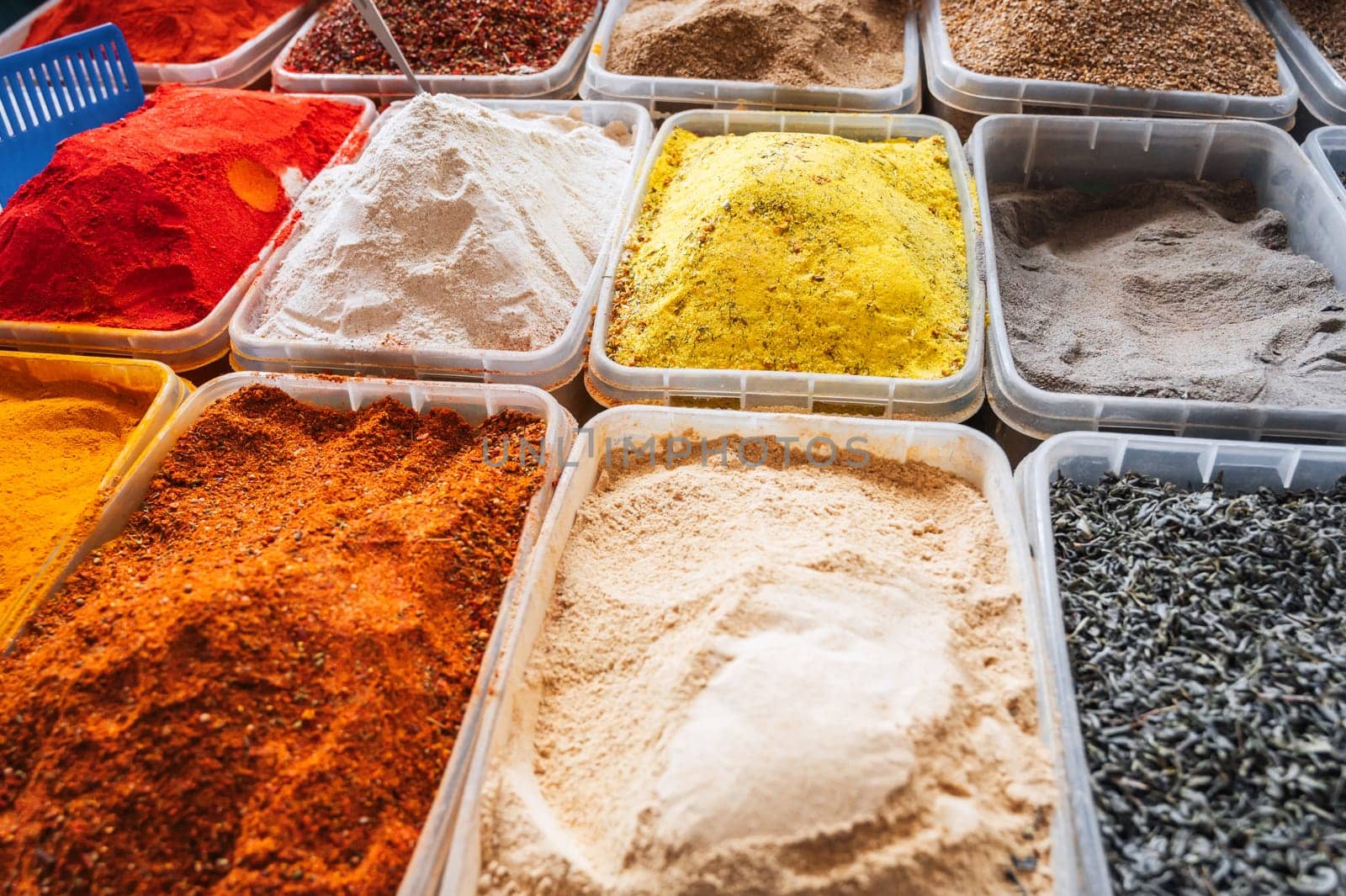 assortment of various oriental indian spices on the counter at the Asian market in India