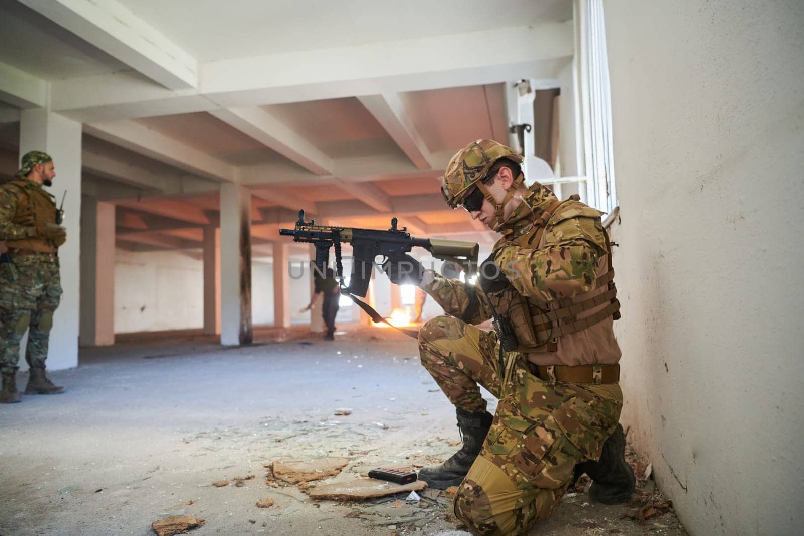 soldier in action near window changing magazine and take cover.