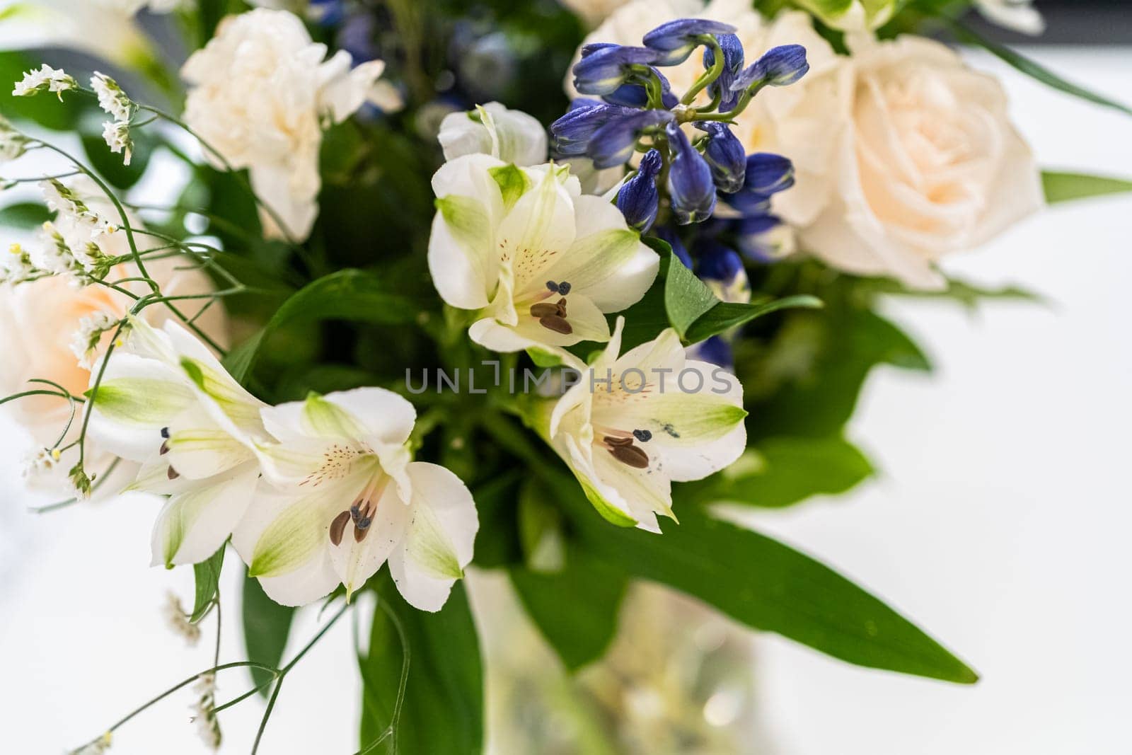 Elegant White Rose Bouquet Adorns a Beautiful Vase by arinahabich