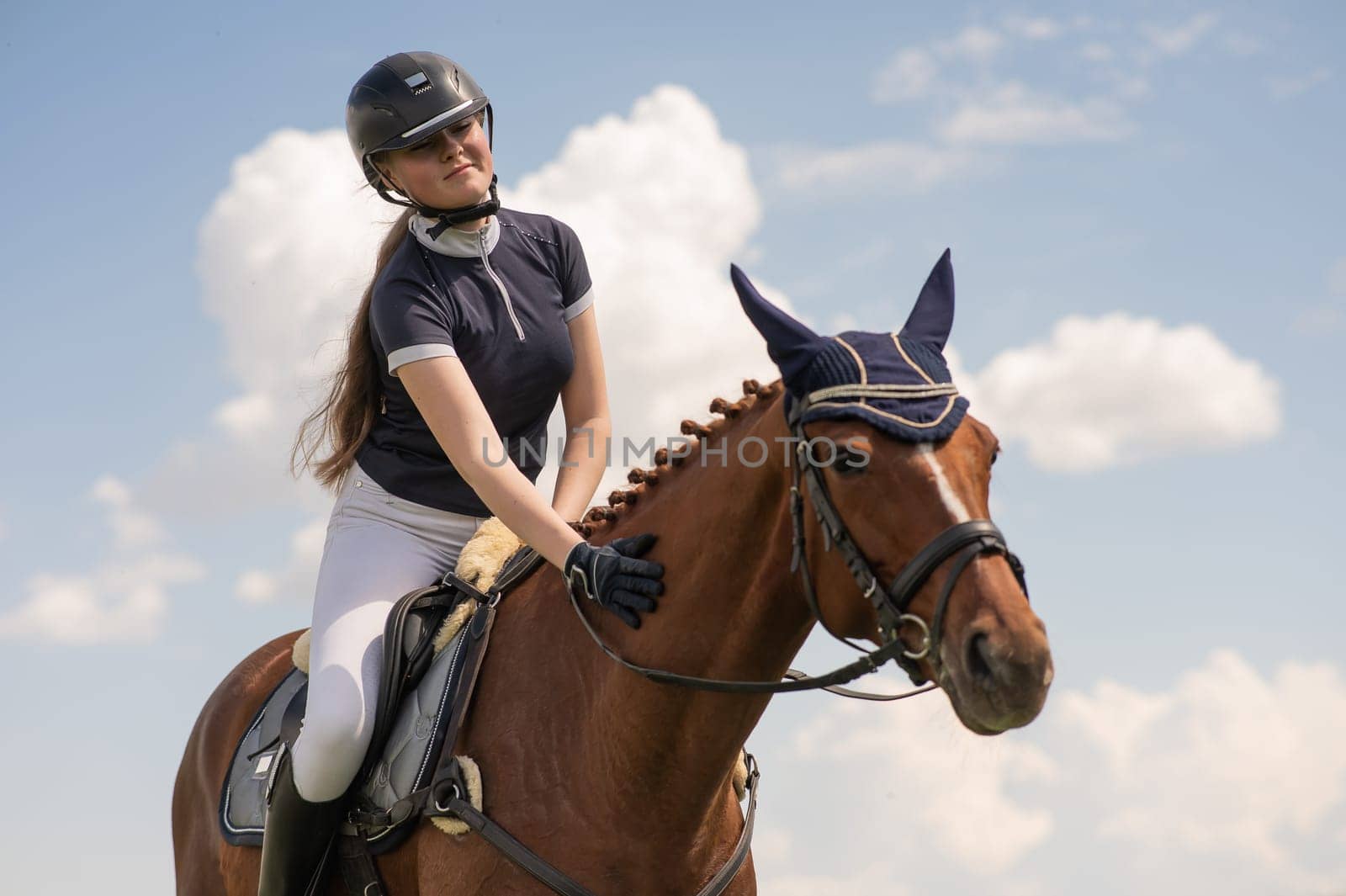 Portrait of a girl jockey riding a horse