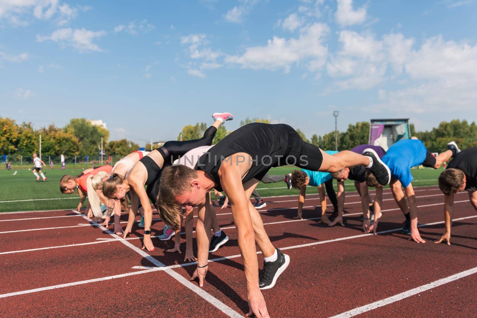 Group of young athlete runnner are training at the stadium outdoors