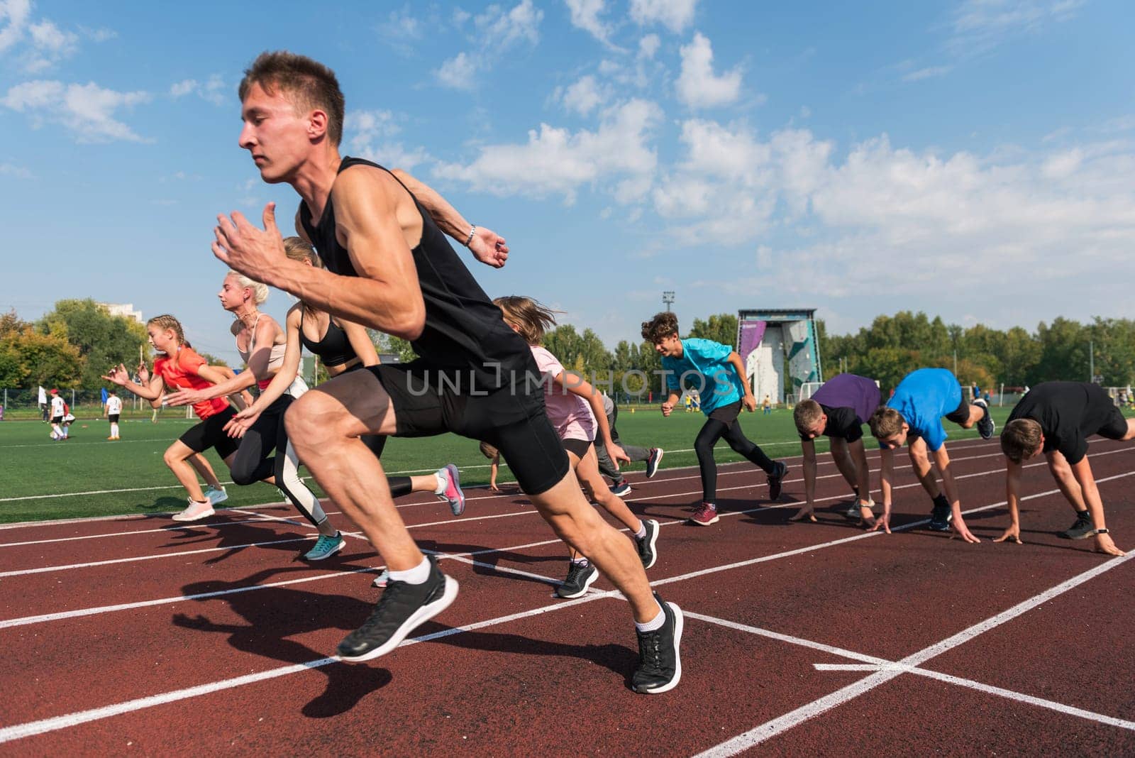 Group of young athlete runnner are training at the stadium outdoors