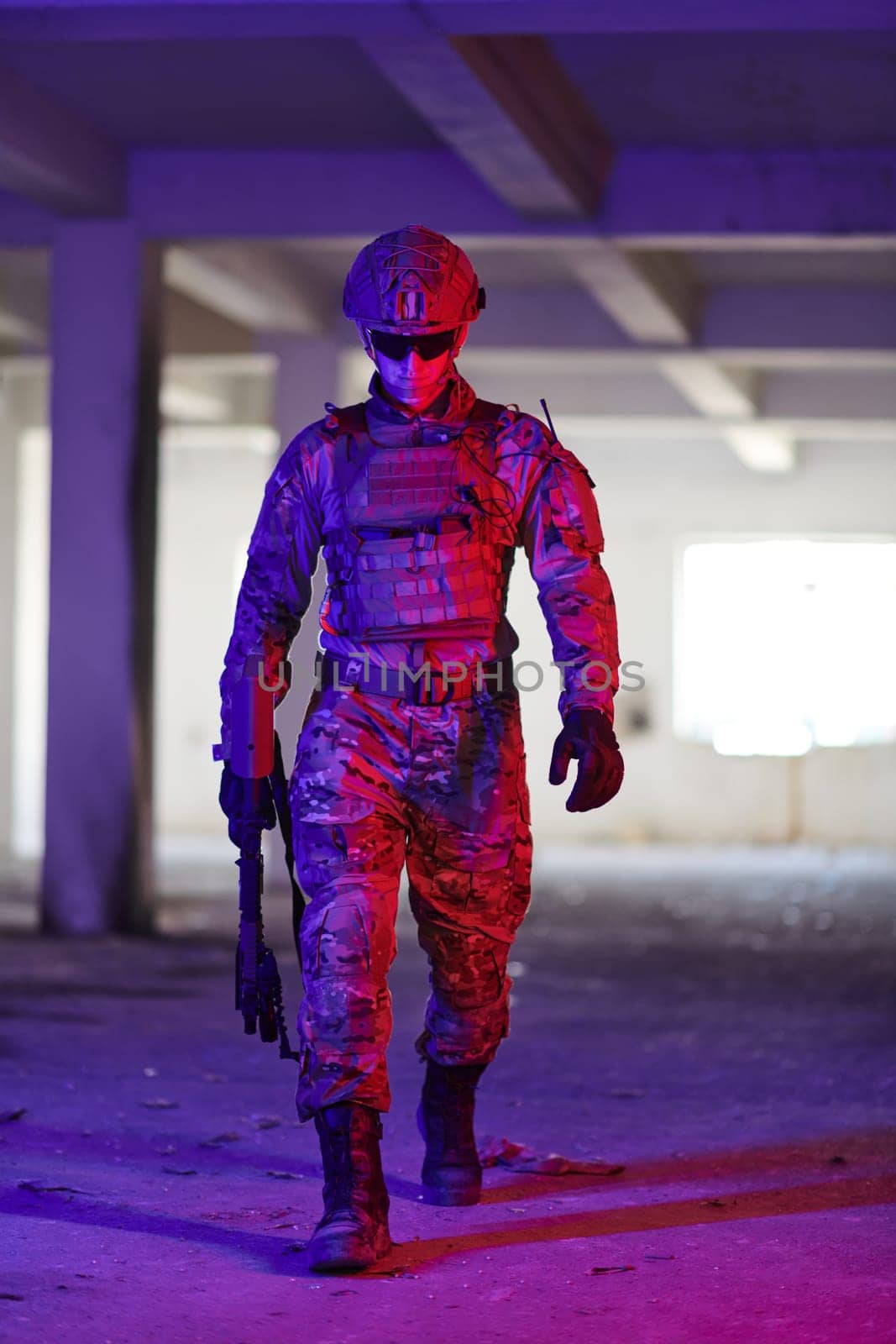 A professional soldier undertakes a perilous mission in an abandoned building illuminated by neon blue and purple lights.