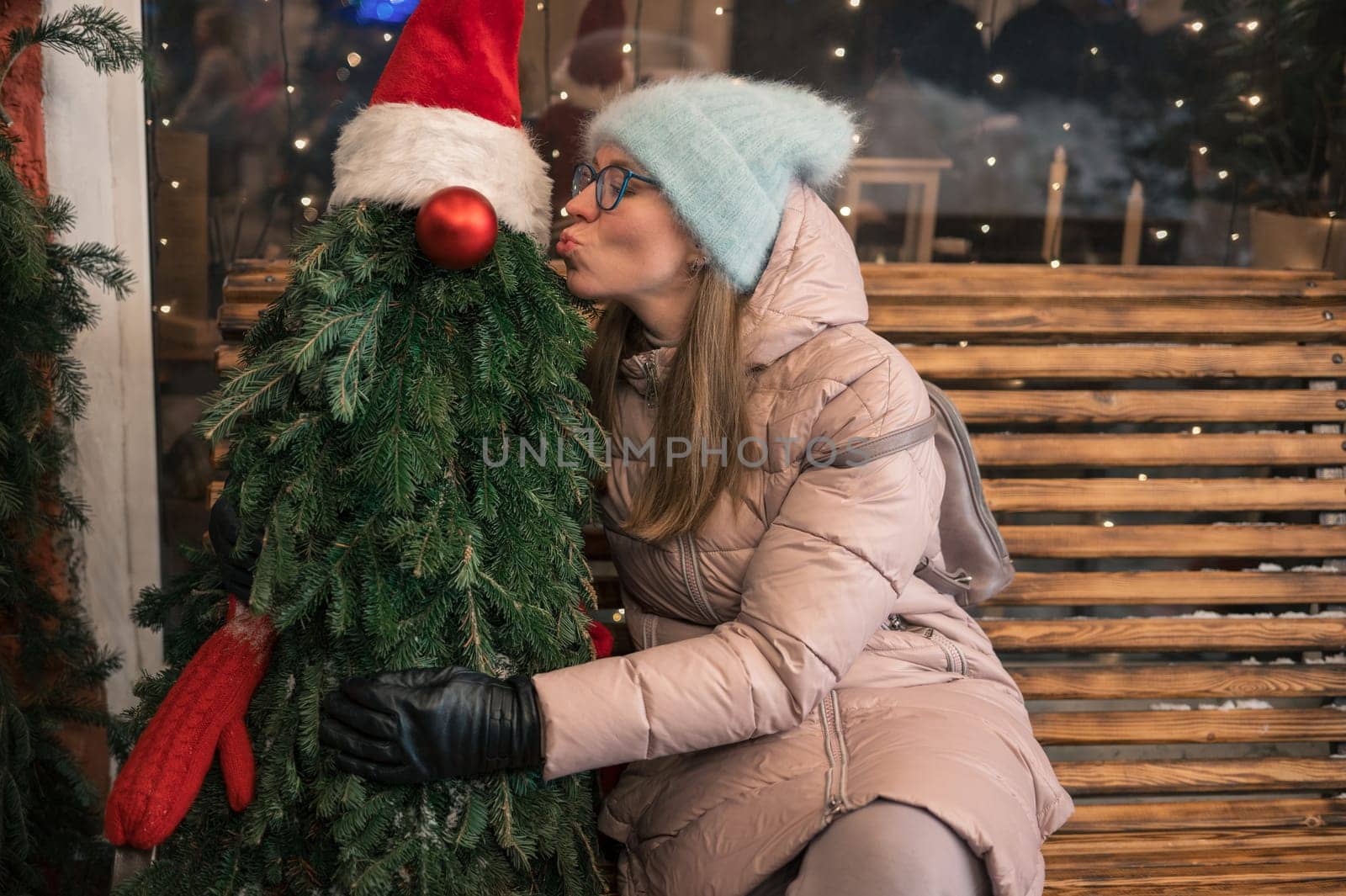 Pretty woman with fir tree decorated mannequin. Xmas holidays, New Year or Christmas concept