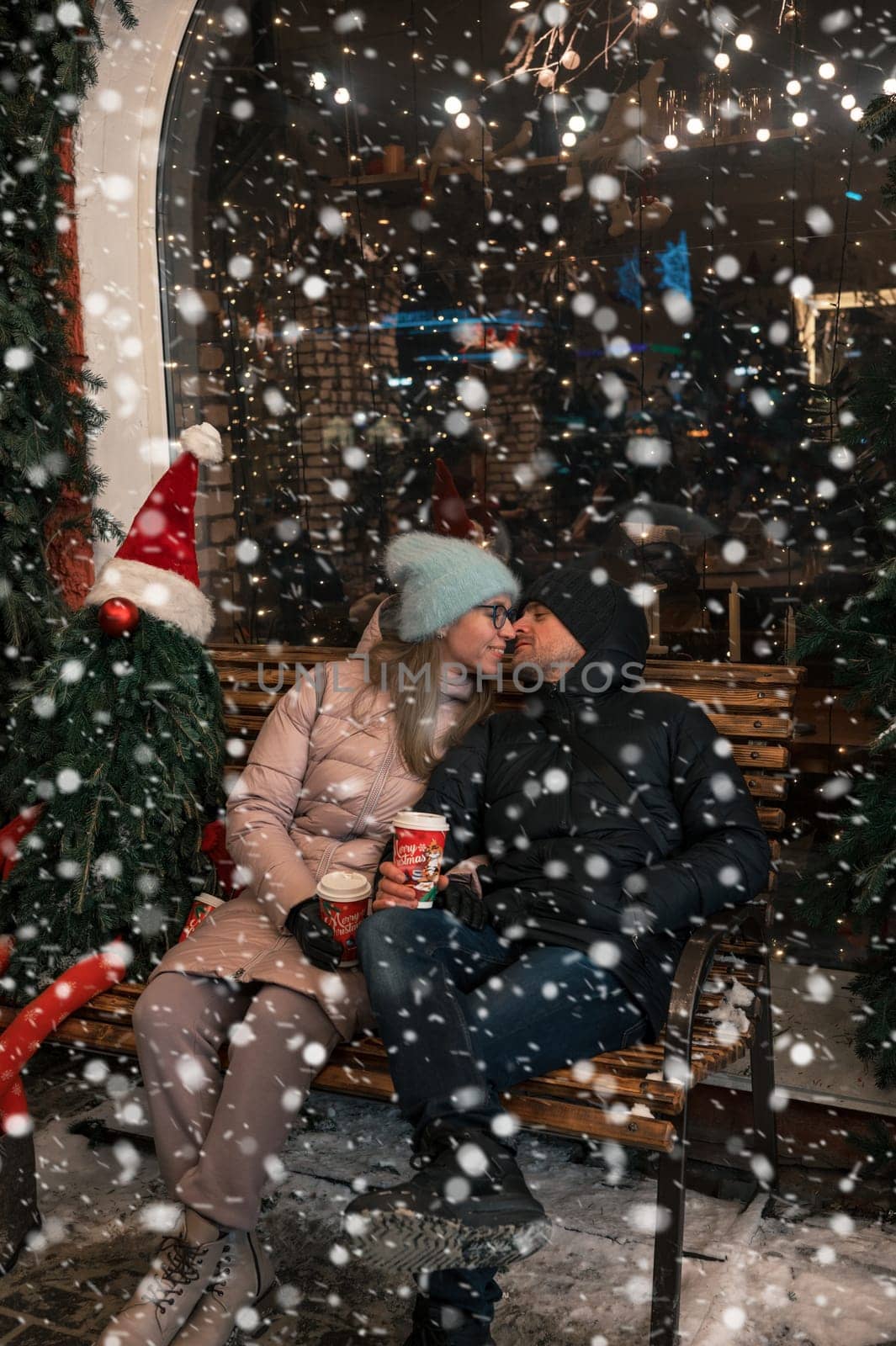 Happy kissing couple with fir tree decorated. Xmas holidays, Happy New Year or Christmas concept