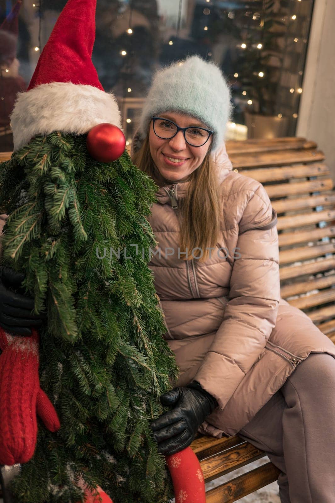Pretty woman with fir tree decorated mannequin. Xmas holidays, New Year or Christmas concept