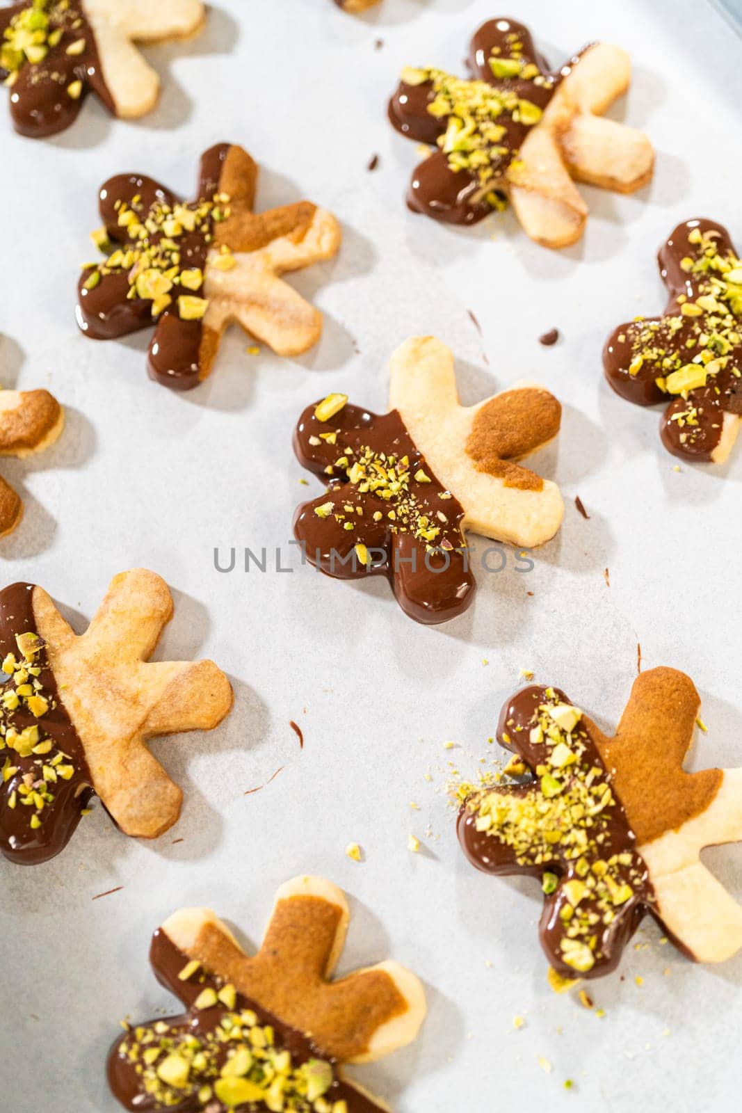 Making Holiday Star Cookies, Chocolate-Dipped with Pistachio Topping by arinahabich