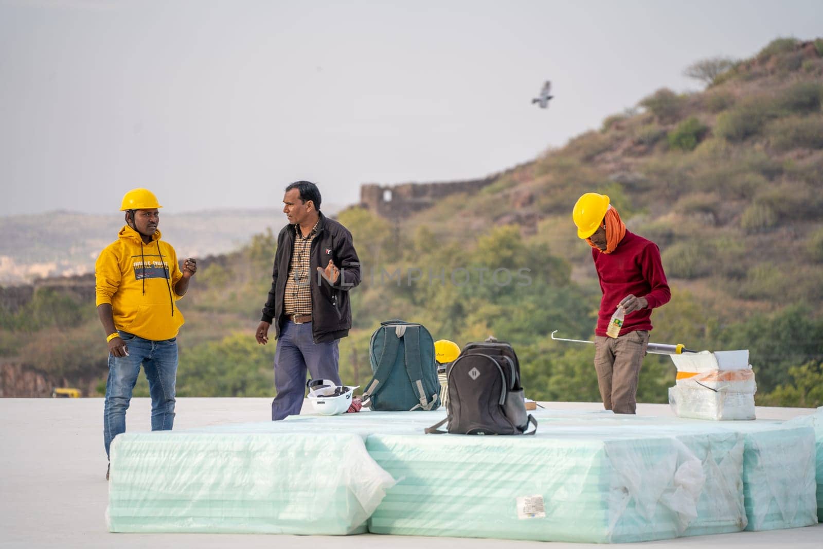 Delhi, India - 21st Dec 2023: Group of construction workers standing on a building looking at the progress showing real estate sector