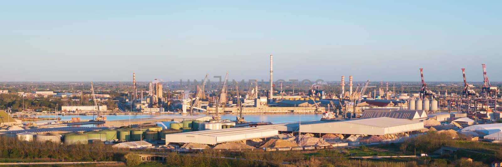 Aerial view of the industrial and port area of Ravenna ,chemical and petrochemical pole,thermoelectric,metallurgical plants and hydrocarbon refinery and liquefied natural gas tanks