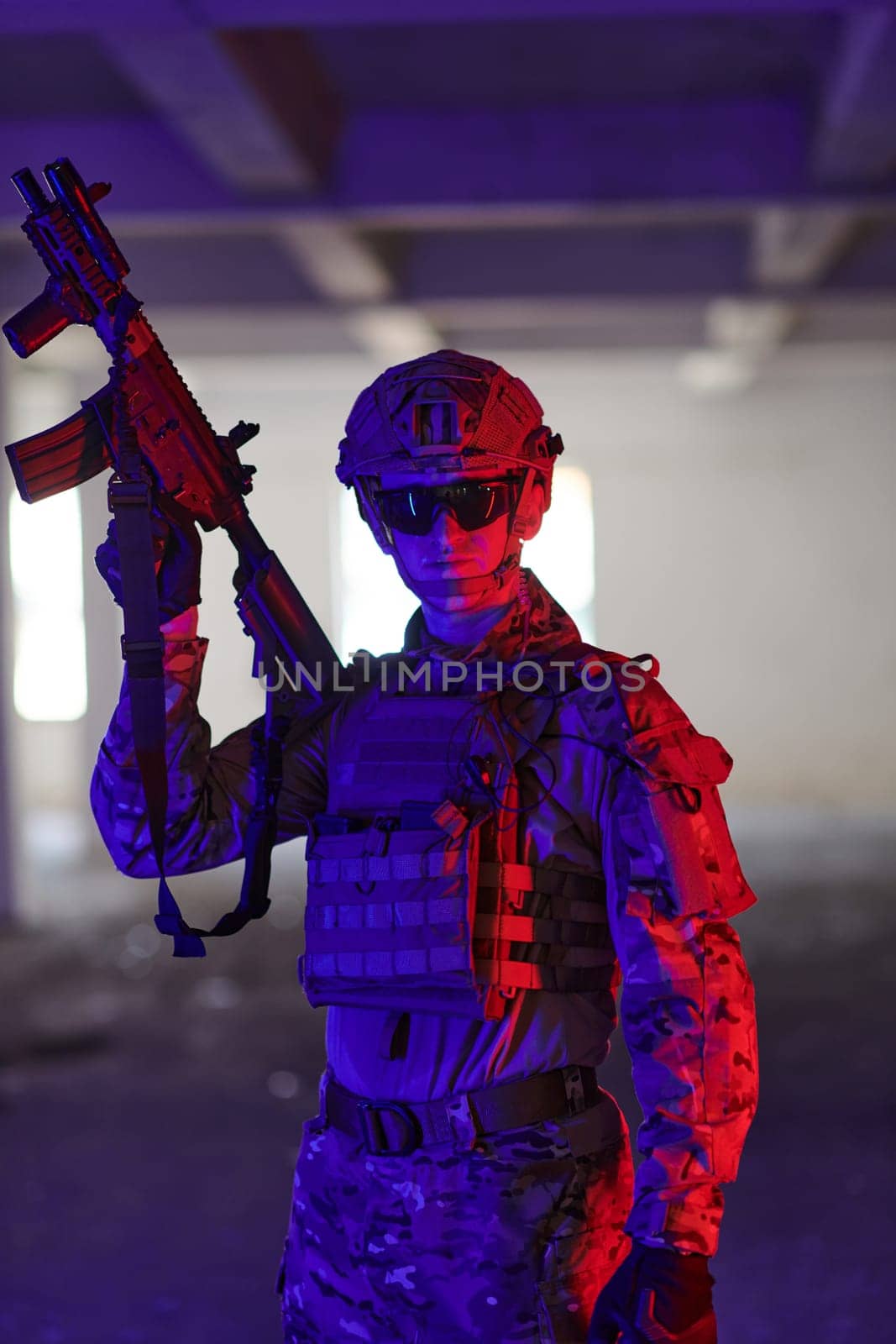 A professional soldier undertakes a perilous mission in an abandoned building illuminated by neon blue and purple lights.