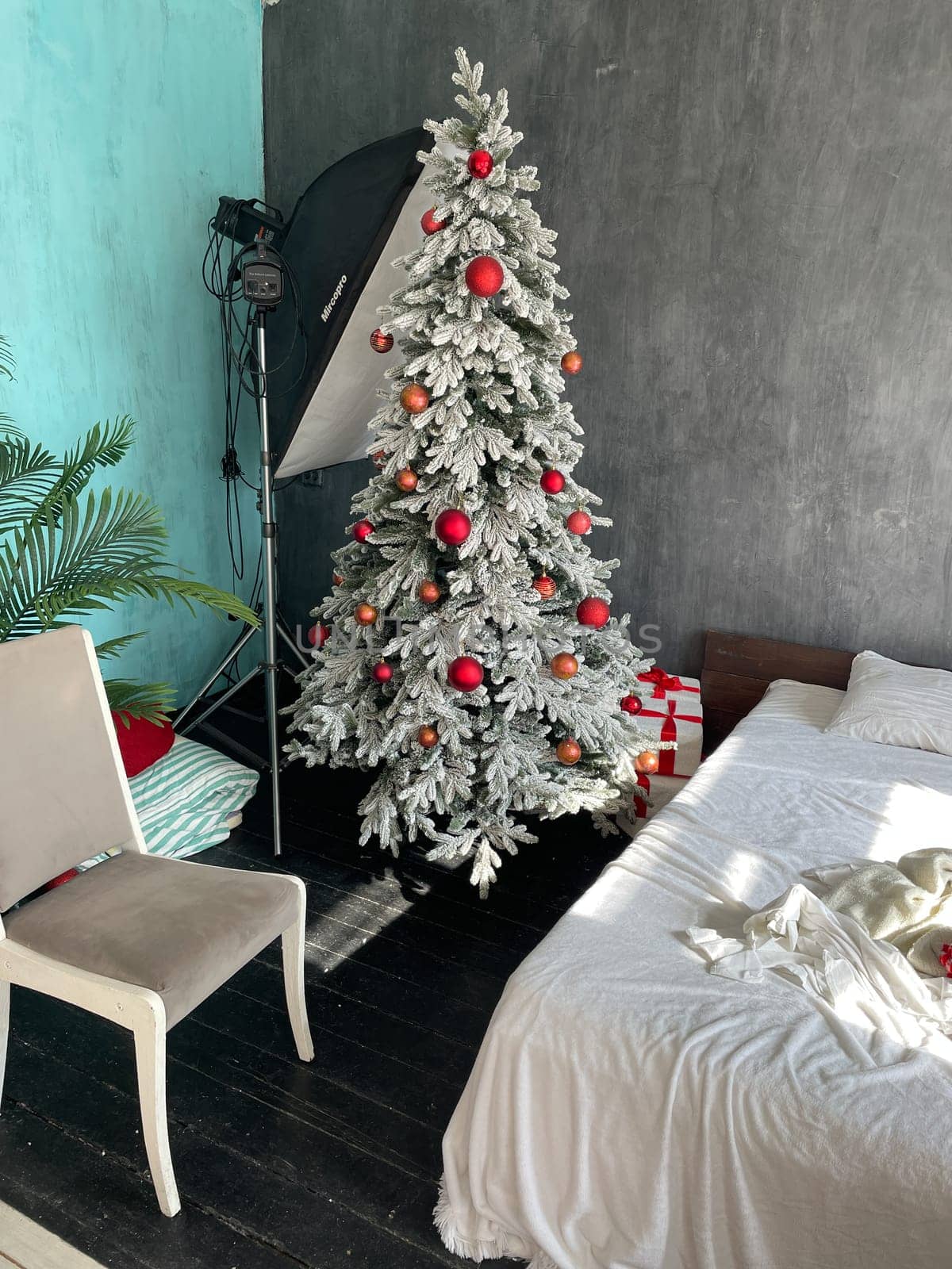 Christmas tree with gifts in the interior of a photo studio