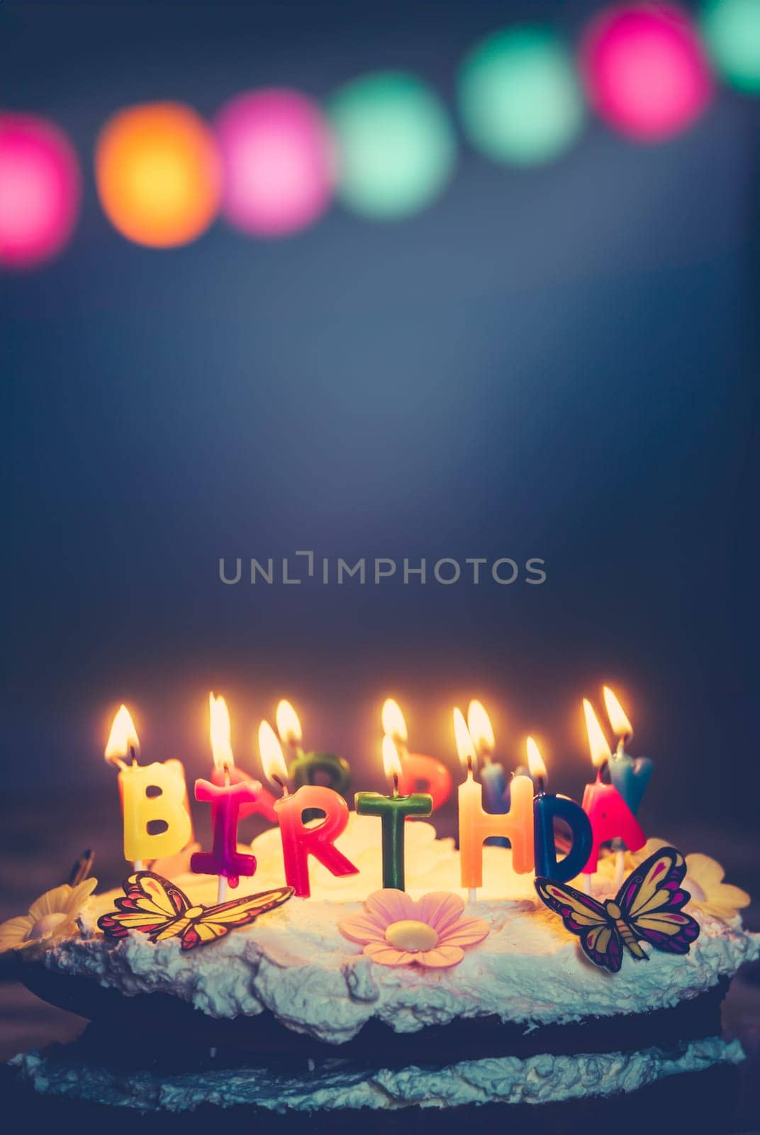 A Birthday Cake With Happy Birthday Candles And Fairy Lights And Copy Space