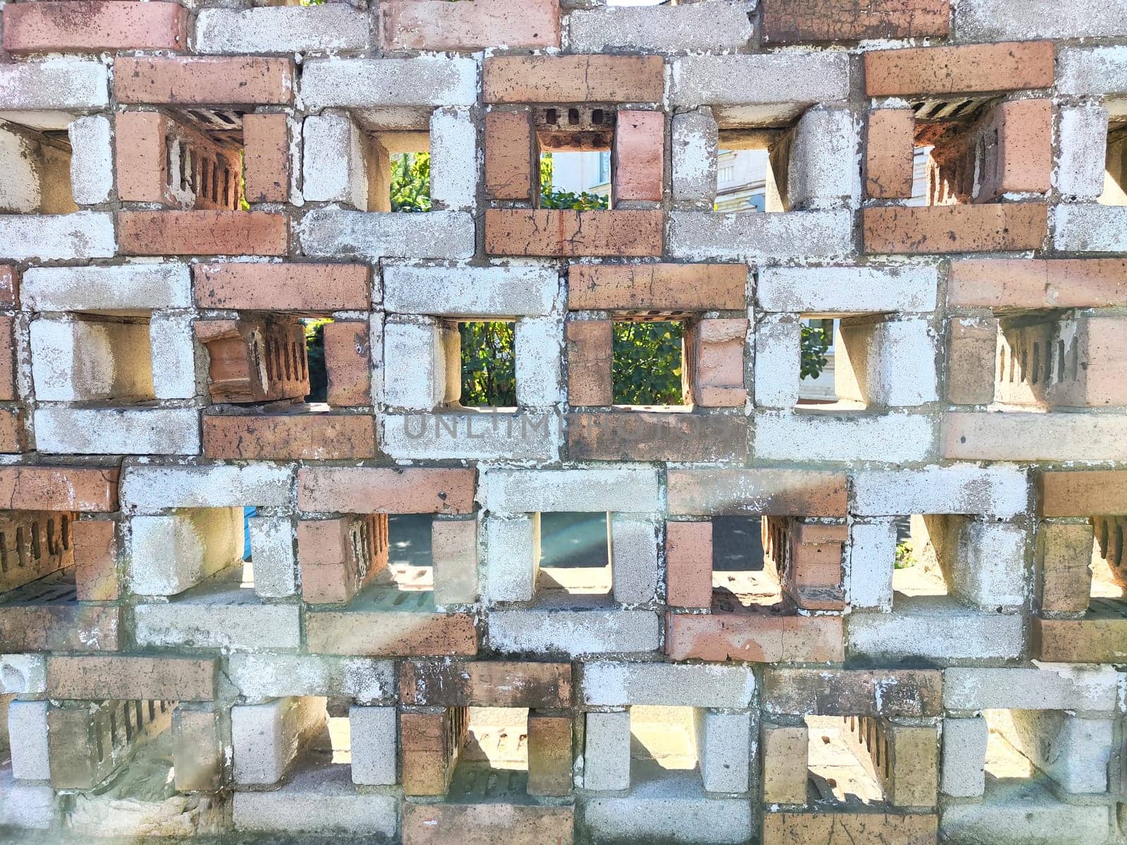Varied brick patterns creating a textured wall with openings. Background, texture, pattern, copy space
