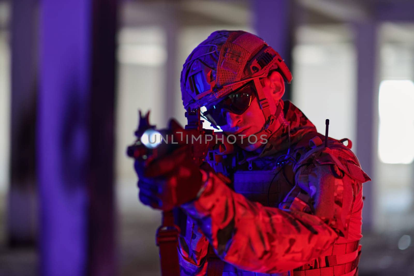 A professional soldier undertakes a perilous mission in an abandoned building illuminated by neon blue and purple lights.