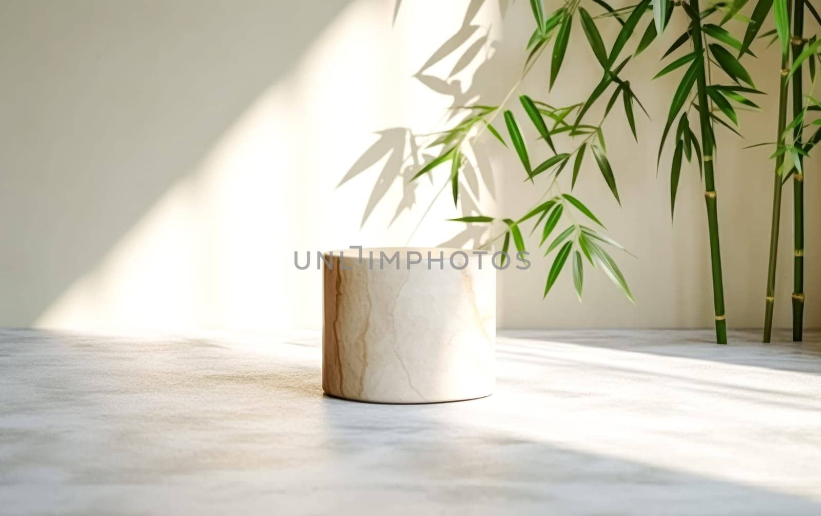 A small white stone table sits in front of a large bamboo plant. The table is empty, and the plant casts a shadow on the floor. The scene is simple and minimalist
