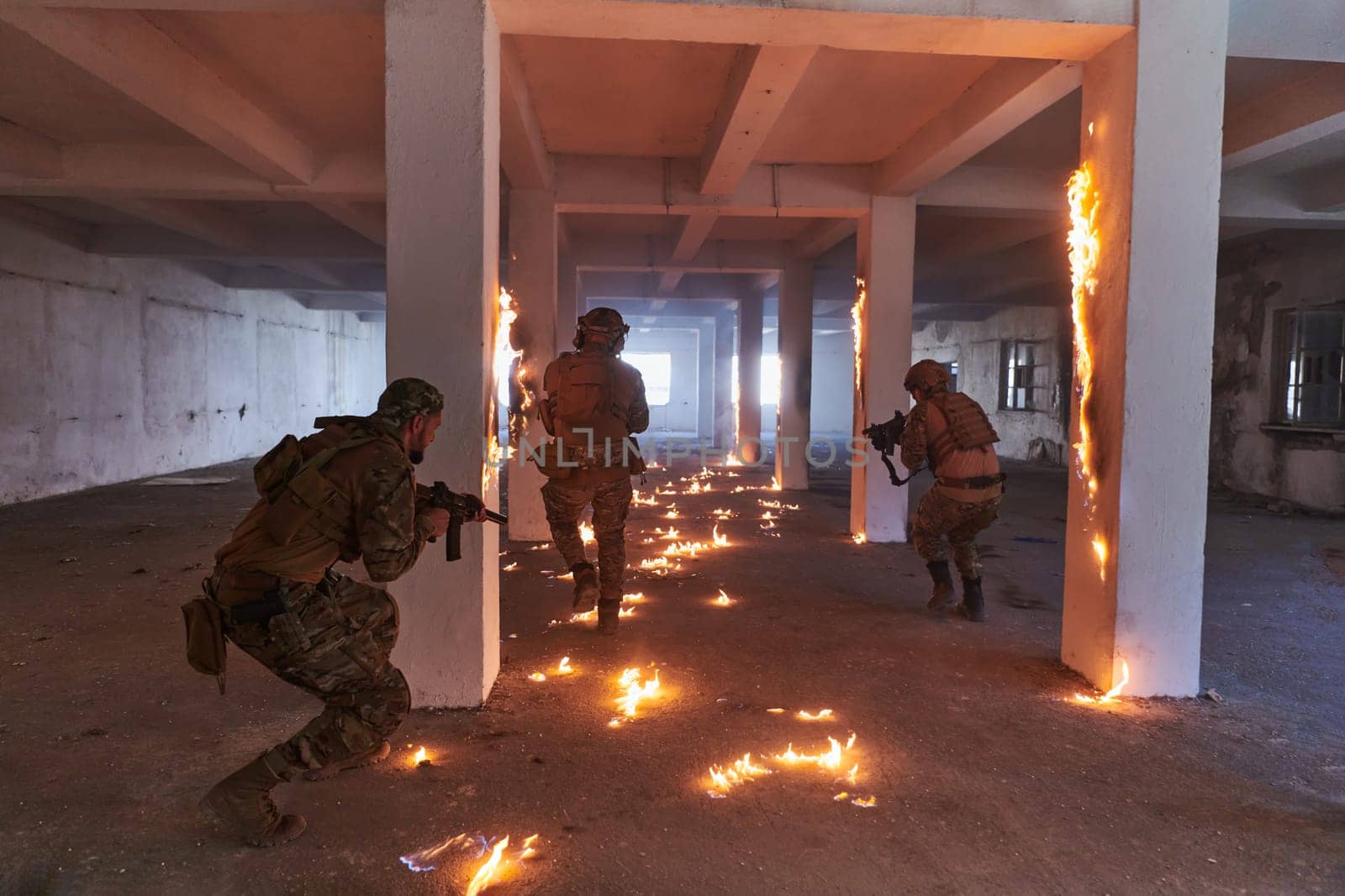 A group of professional soldiers bravely executes a dangerous rescue mission, surrounded by fire in a perilous building