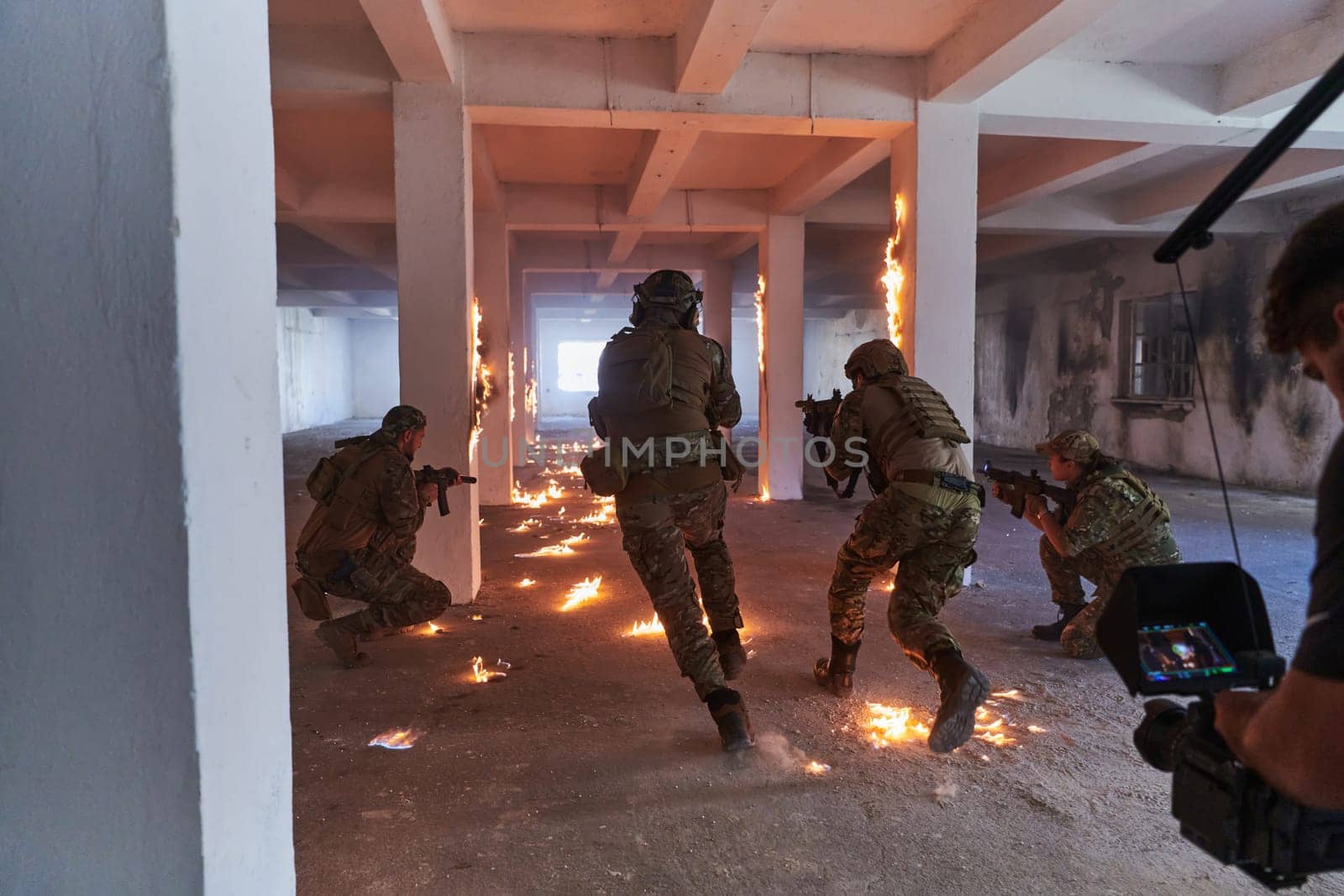 A professional cameraman captures the intense moments as a group of skilled soldiers embarks on a dangerous mission inside an abandoned building, their actions filled with suspense and bravery.