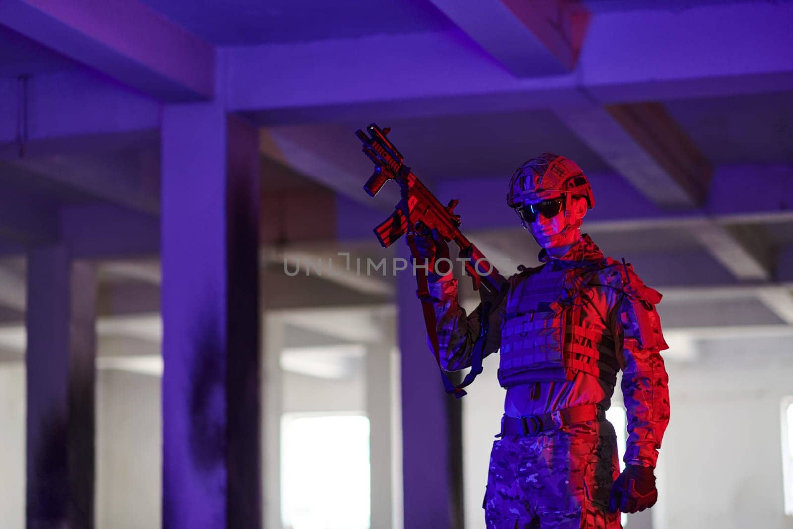 A professional soldier undertakes a perilous mission in an abandoned building illuminated by neon blue and purple lights.