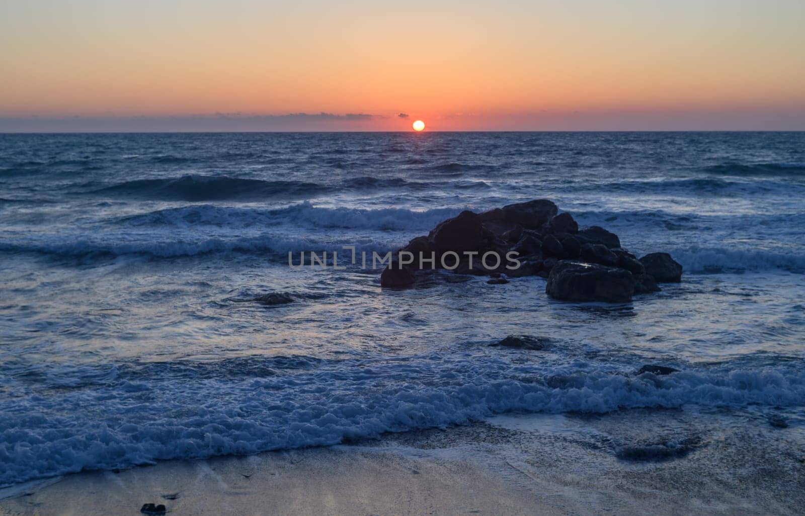 waves of the sea break on the rocks. Mediterranean Sea near the small Village