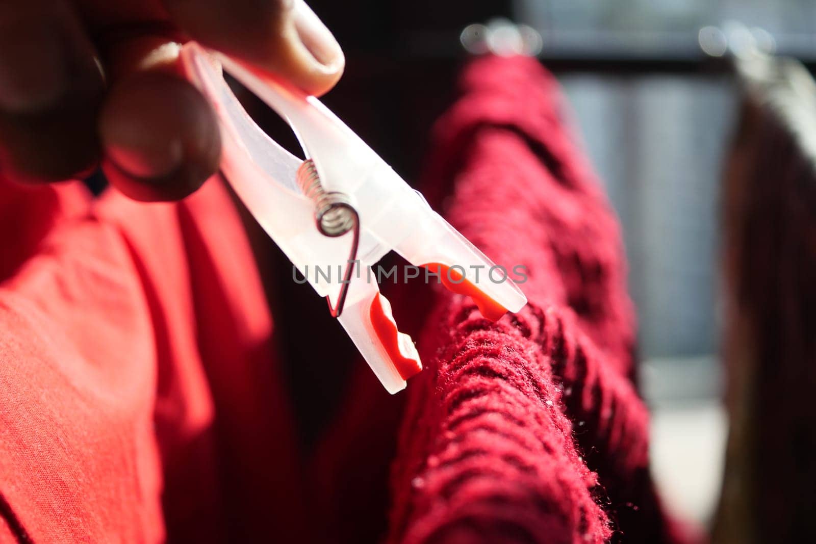 putting a blue clothespins on cloth ,