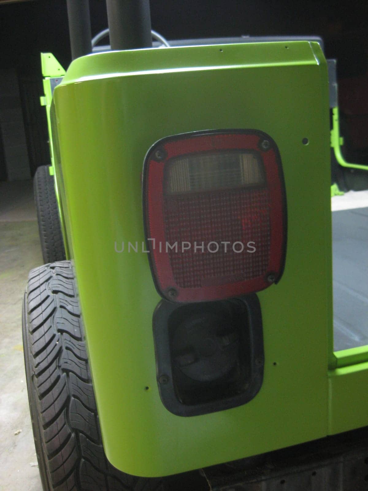 Tail Light and Gas Cap, Lime Green Paint Job, 1990s Vehicle . High quality photo