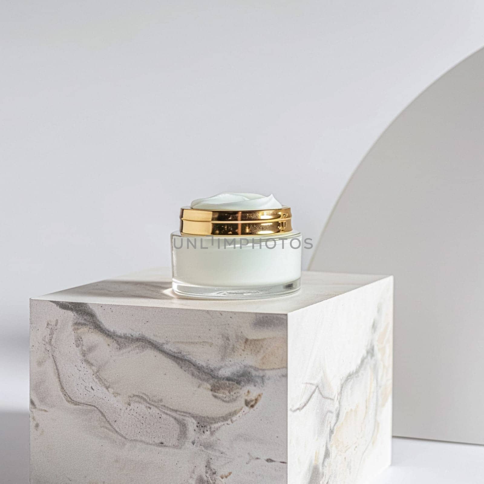 Face cream in a glass jar on a white and gold background. Skin care concept. Backdrop for beauty cosmetic products