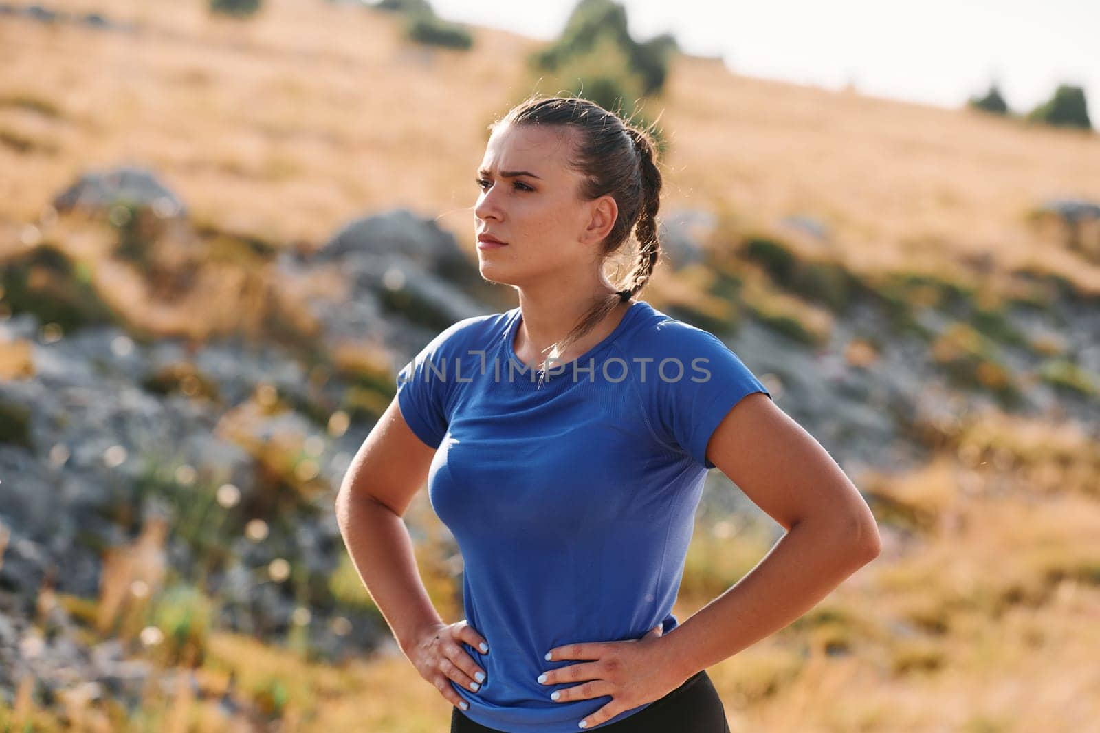 A determined female athlete is captured in preparation mode for her morning run, showcasing dedication and focus in her fitness routine
