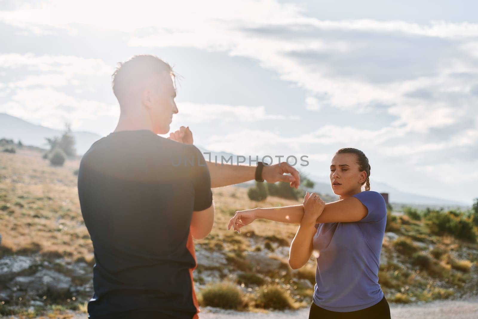 A couple engages in post-run stretching, fostering flexibility and recovery after an intense morning jog, promoting health and well-being in their fitness routine