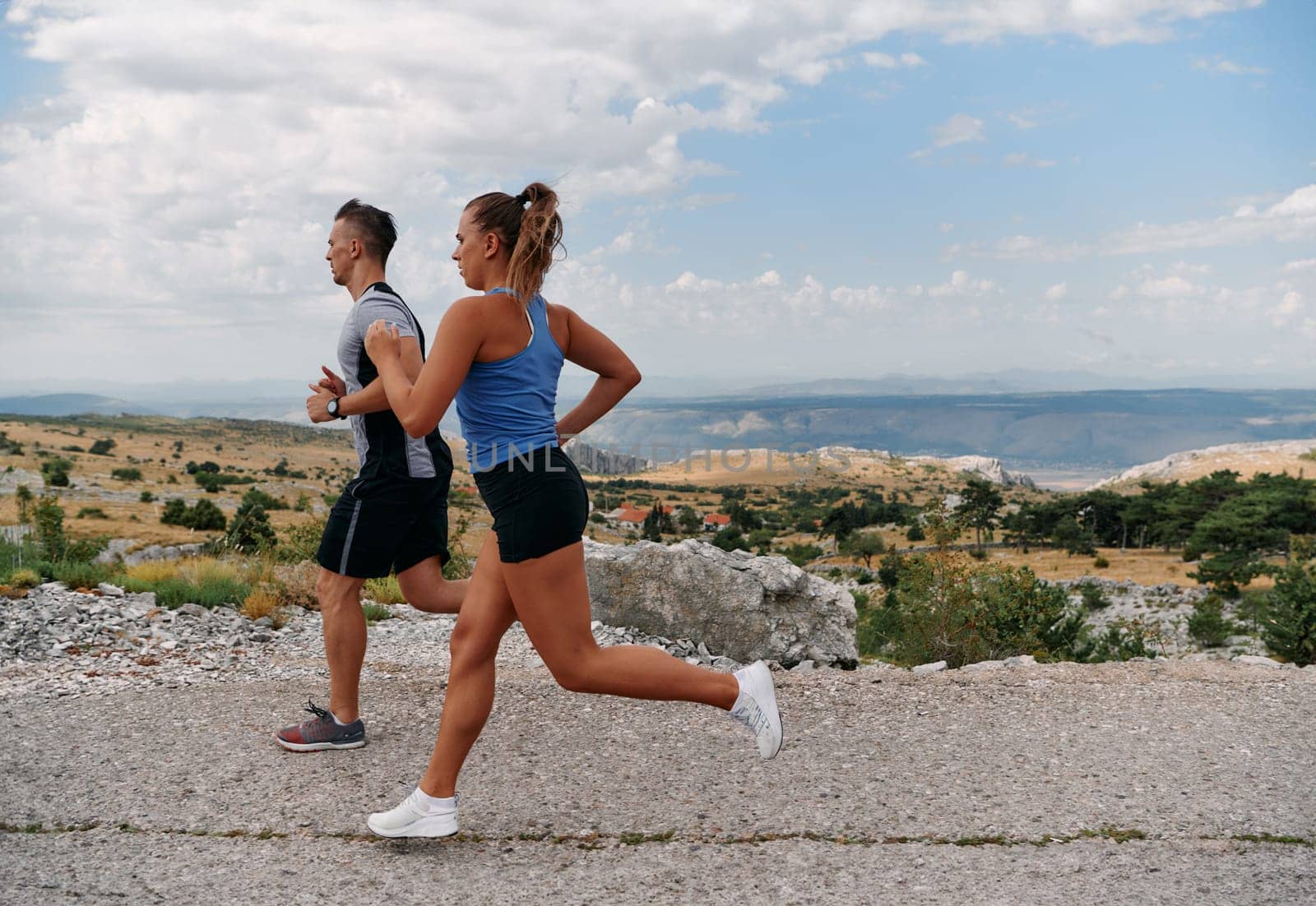 Couple conquer challenging mountain trails during an invigorating morning run.