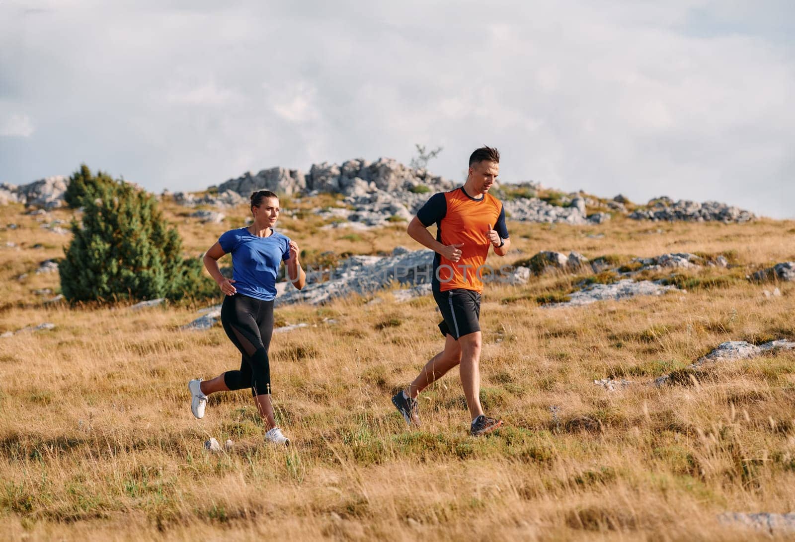 Couple conquer challenging mountain trails during an invigorating morning run.