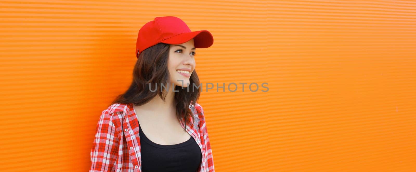 Summer portrait of happy smiling young woman posing in red baseball cap, casual clothes by Rohappy