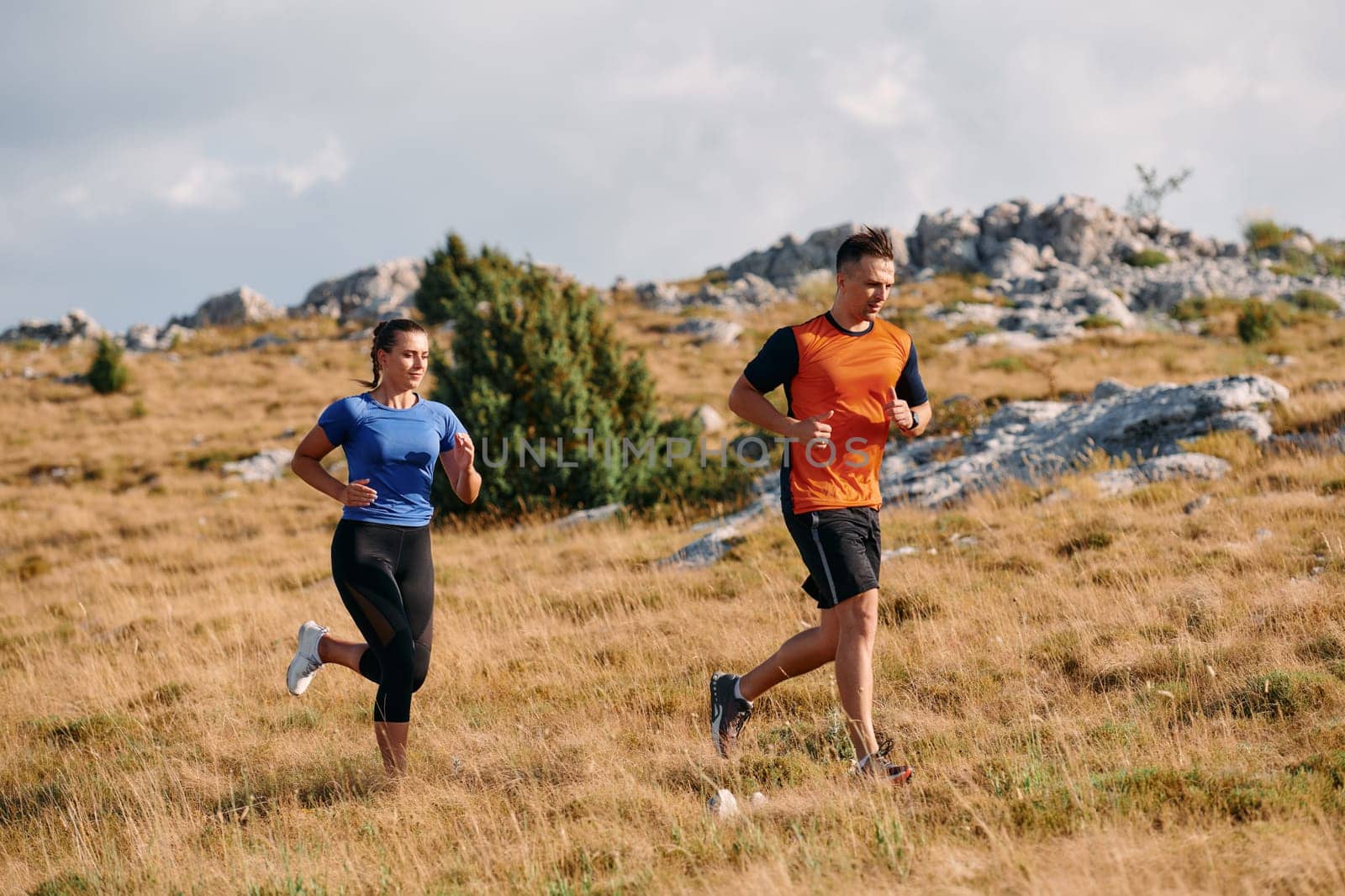 Couple conquer challenging mountain trails during an invigorating morning run.