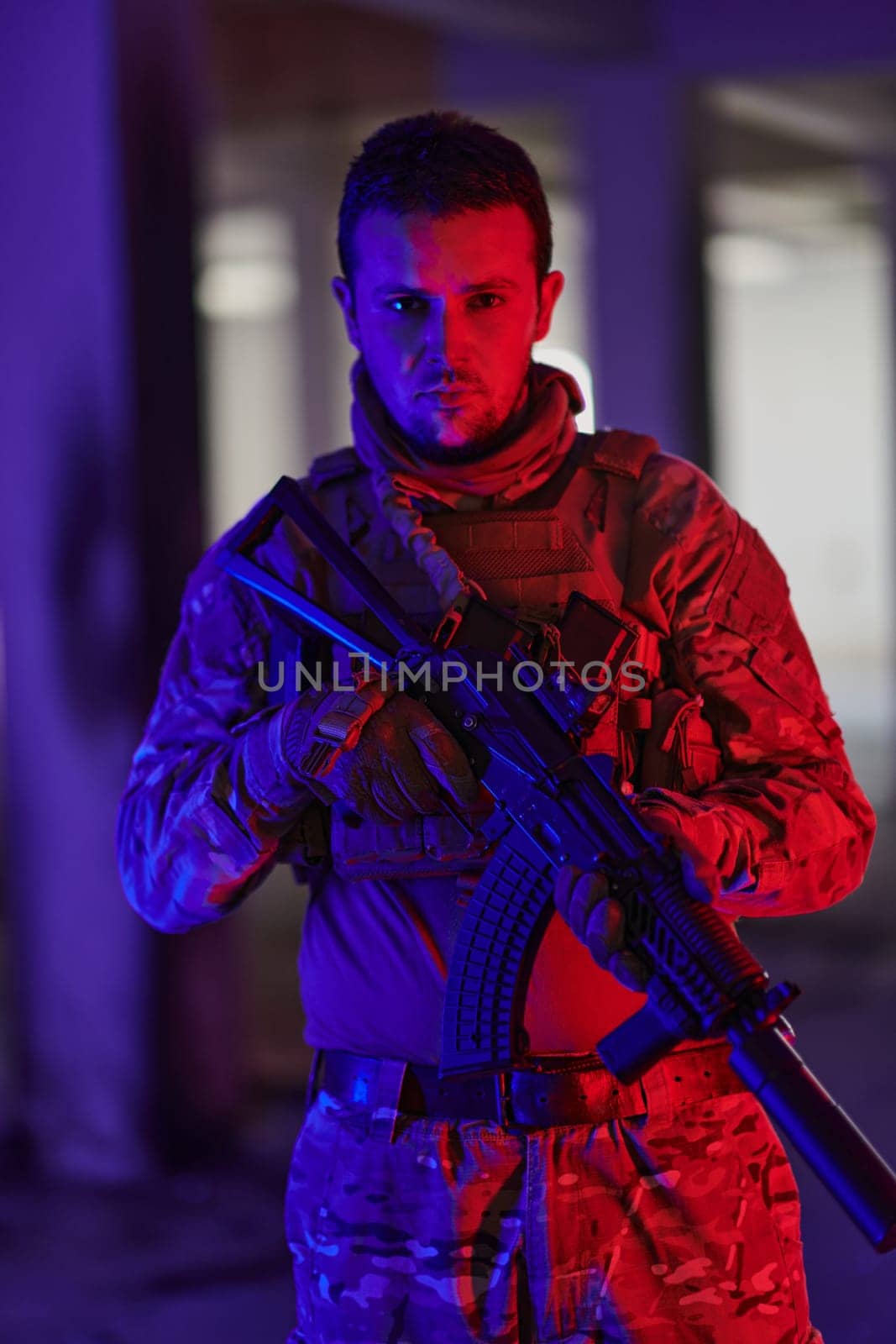 A professional soldier undertakes a perilous mission in an abandoned building illuminated by neon blue and purple lights.