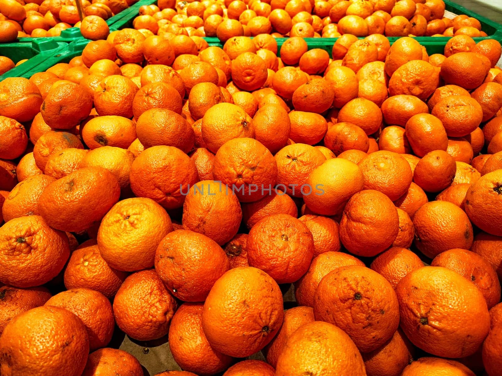 A Multitude of Fresh Oranges on Display at a Market Stall. Piles of vibrant oranges creating colorful texture in a market