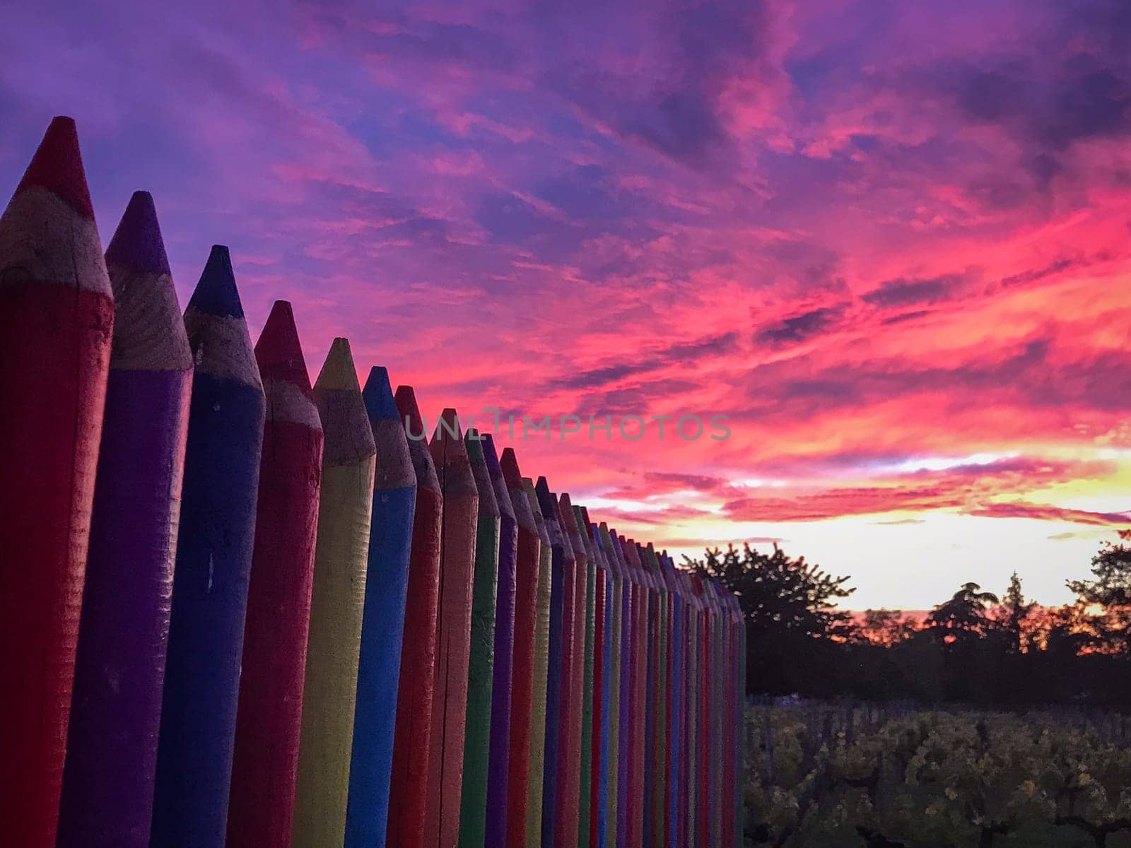 A beautiful image of a school wall in coloured pencils against a blushing evening sky, High quality photo