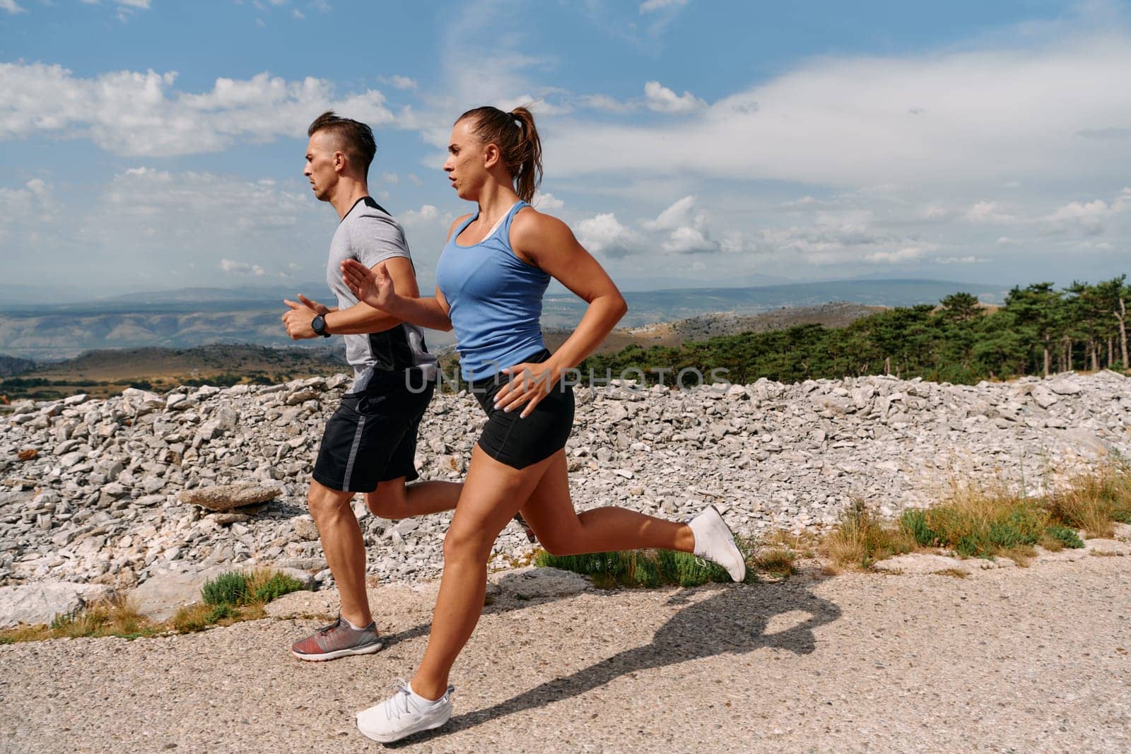 Couple conquer challenging mountain trails during an invigorating morning run.