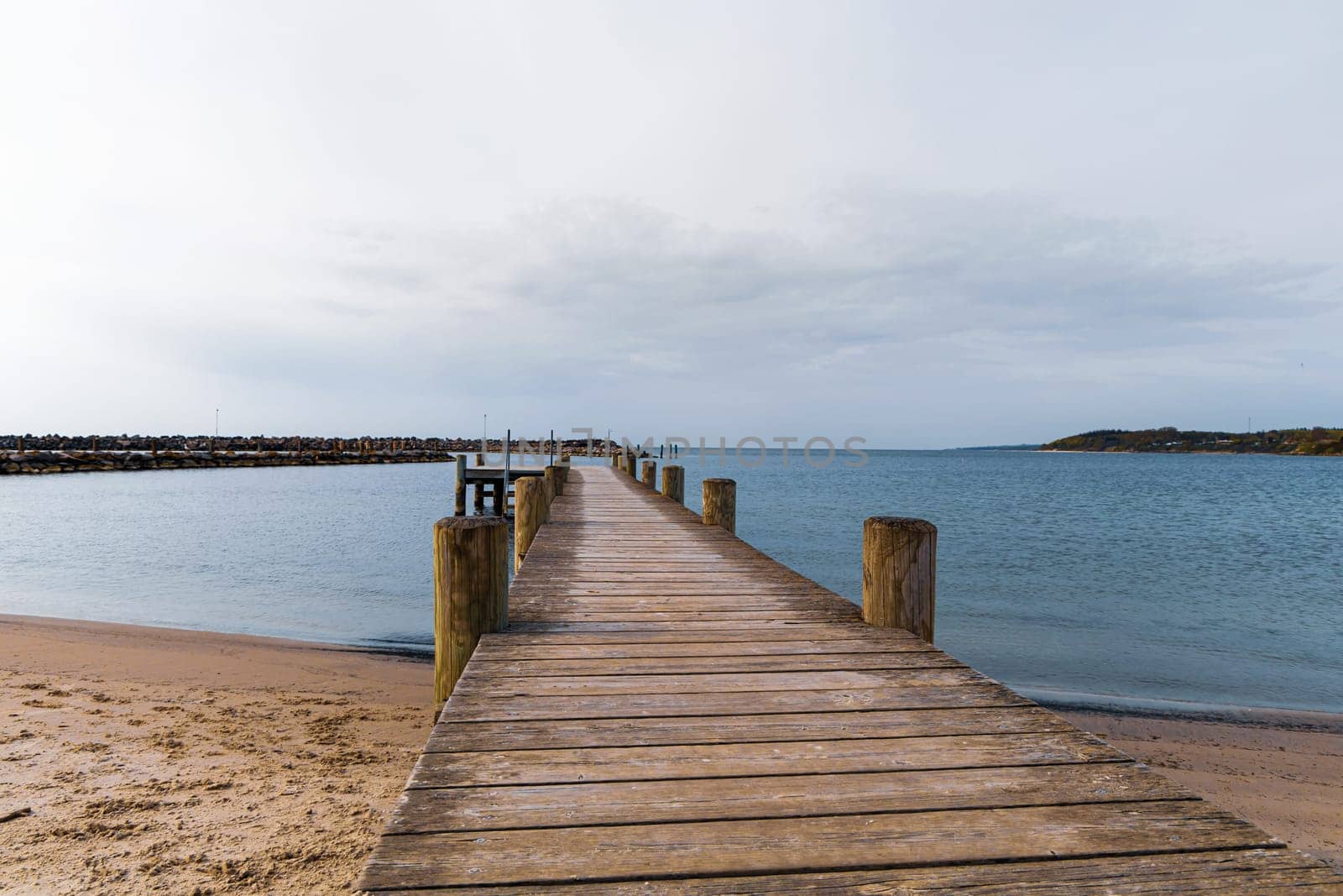 Long wooden pier on the sea. Beautiful landscape view.