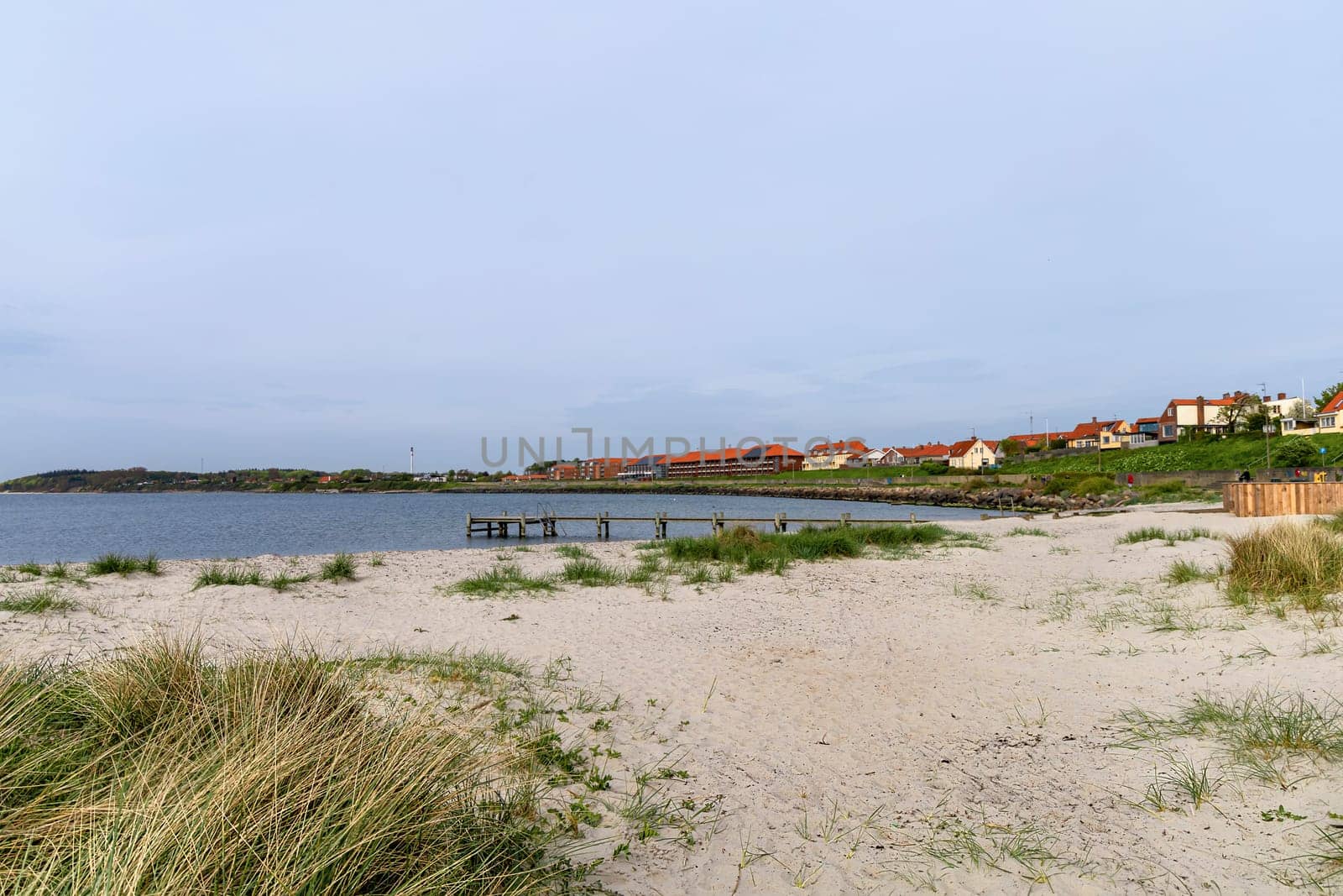 Beautiful natural beach with sand and grass in the town of Ronne on the Bornholm Island, Denmark.