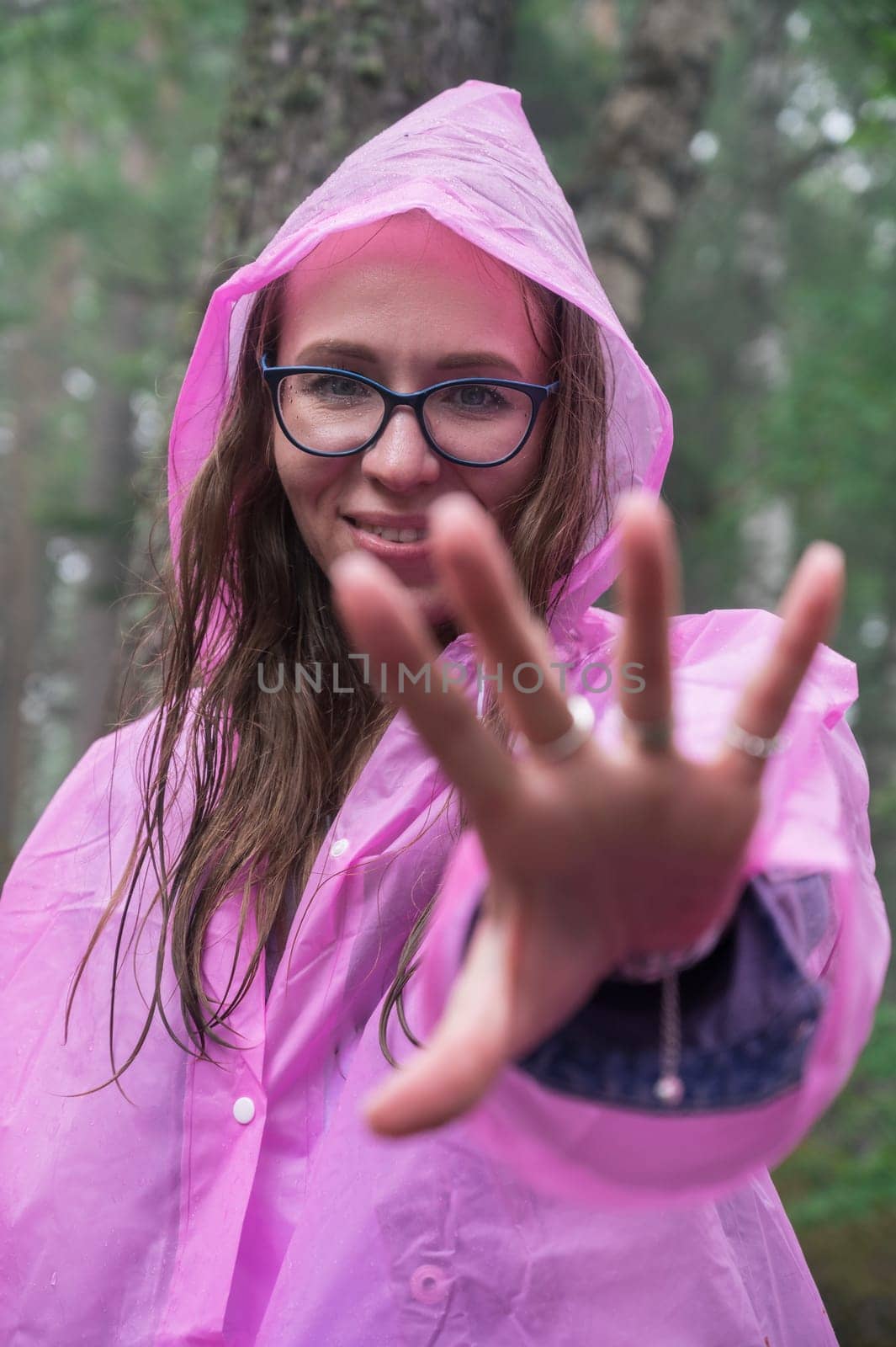 Woman in the raincoat the taiga forest and rocks of the Stolby nature reserve park, Krasnoyarsk, Russia