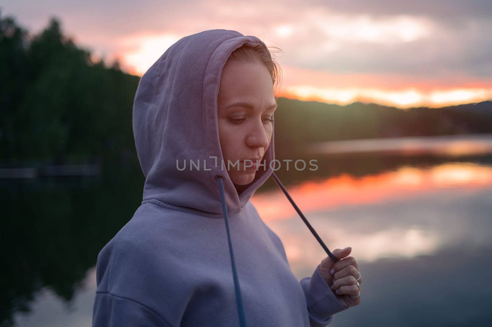 Woman sitting on the pier, closeup portrait, beauty summer sunset