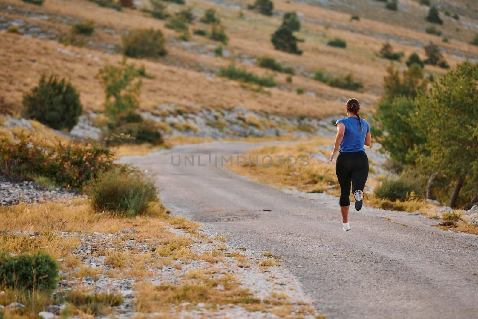 Empowered Runner Embracing Nature's Beauty on a Serene Morning Trail. by dotshock