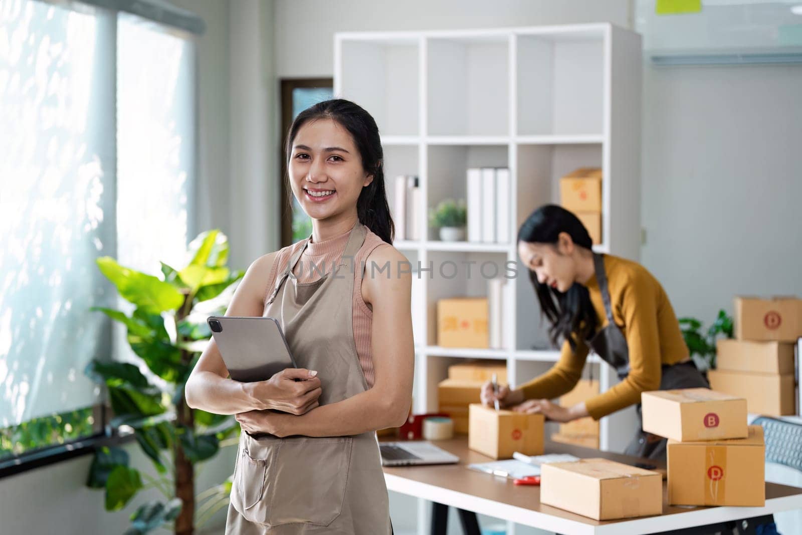 Entrepreneur startup business woman sme holding tablet. Small Online Business Owner, Online Marketing and Product Packing and Delivery Service. E-commerce concept.
