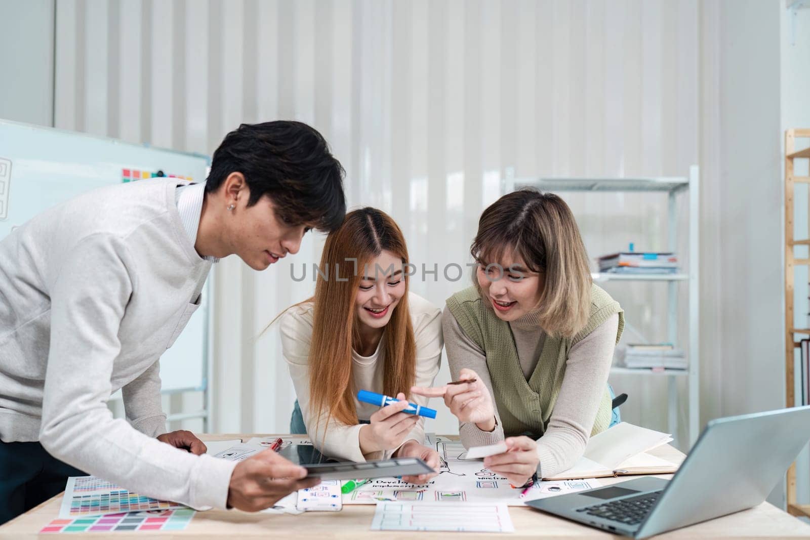 Group of ux developer and ui designer brainstorming about app interface design at modern office. Creative digital development agency.