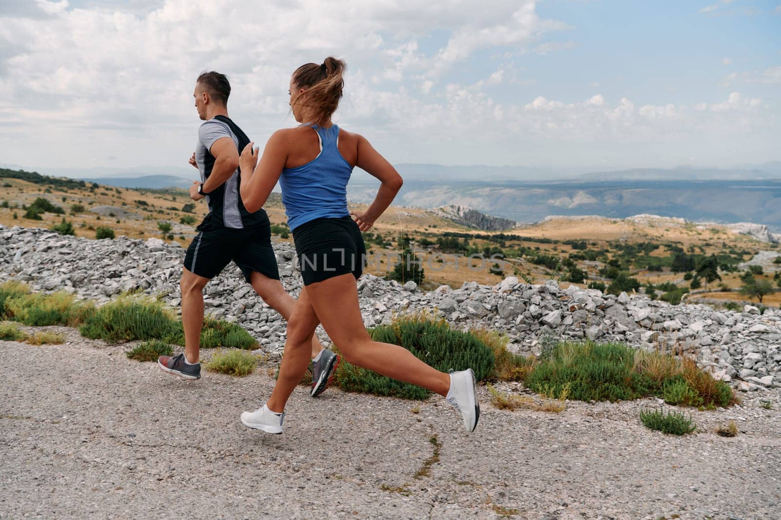 Couple conquer challenging mountain trails during an invigorating morning run.